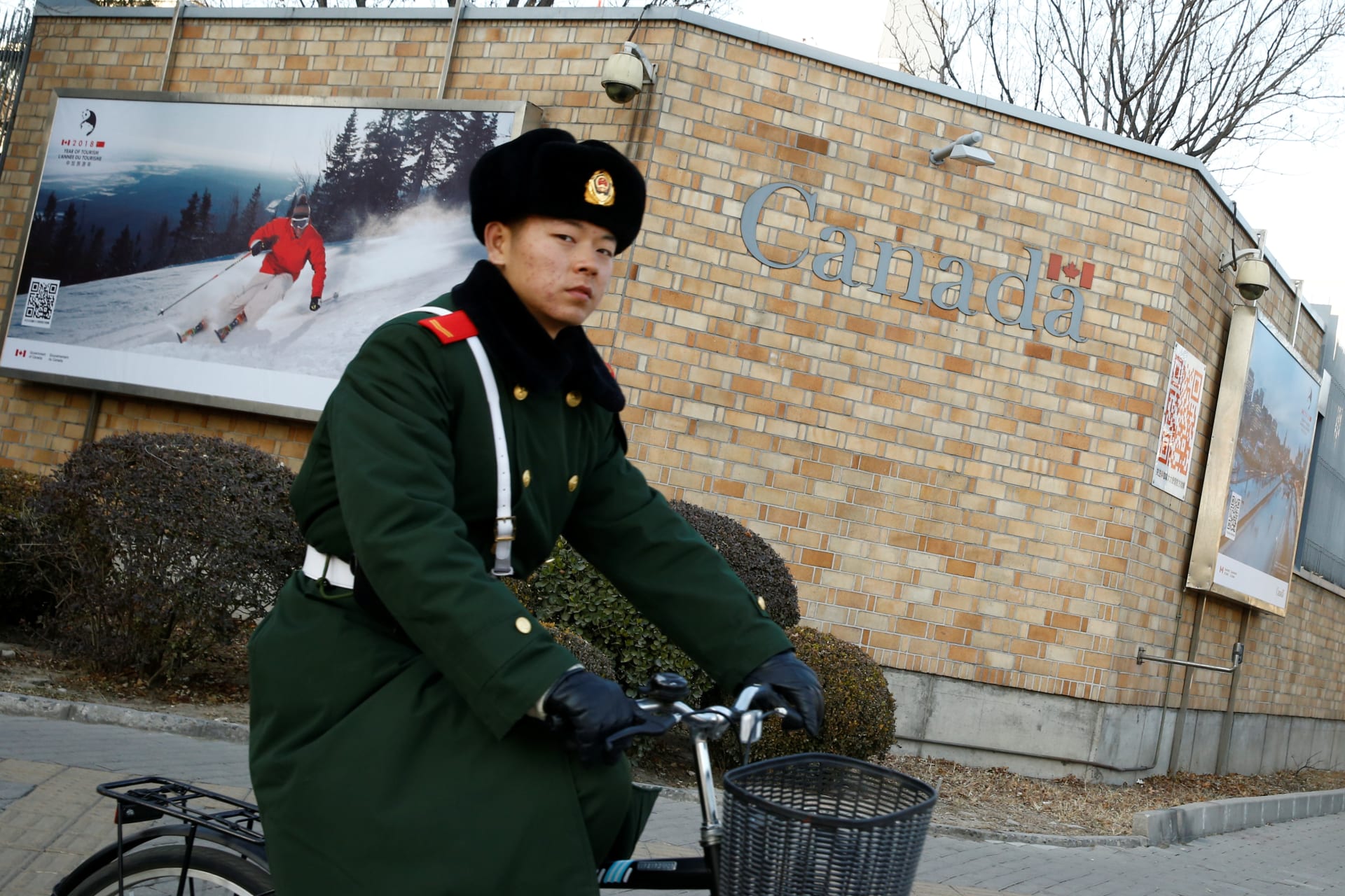 <p>A paramilitary police officer cycles past the embassy of Canada in Beijing, China on December 12, 2018.</p>
