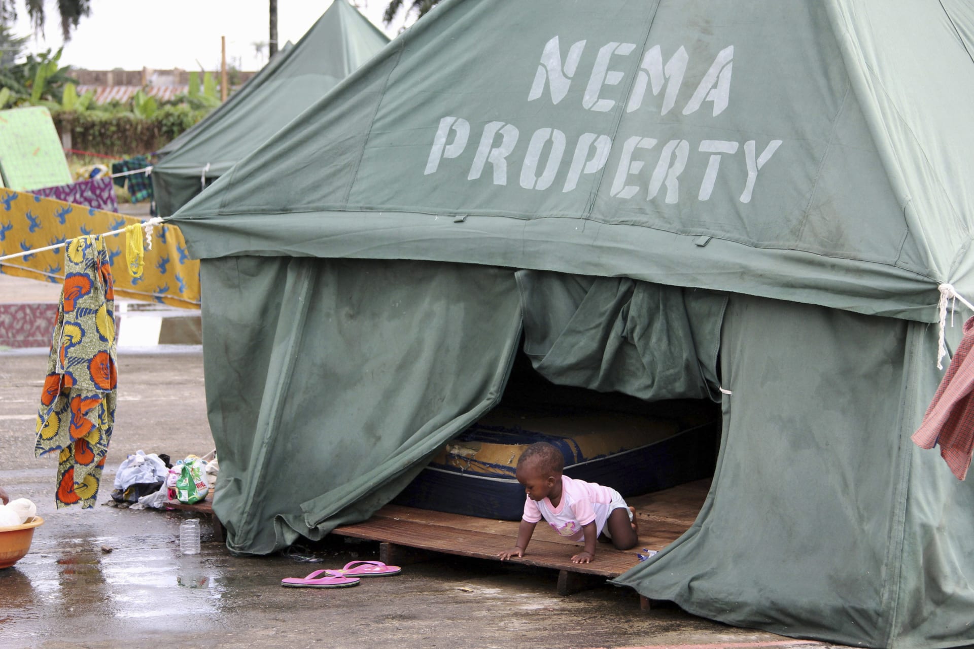 <p>A child is seen crawling in a tent belonging to the National Emergency Management Agency (NEMA) at a relief centre for flood victims in Igbogene community Bayelsa state October 12, 2012.</p>
