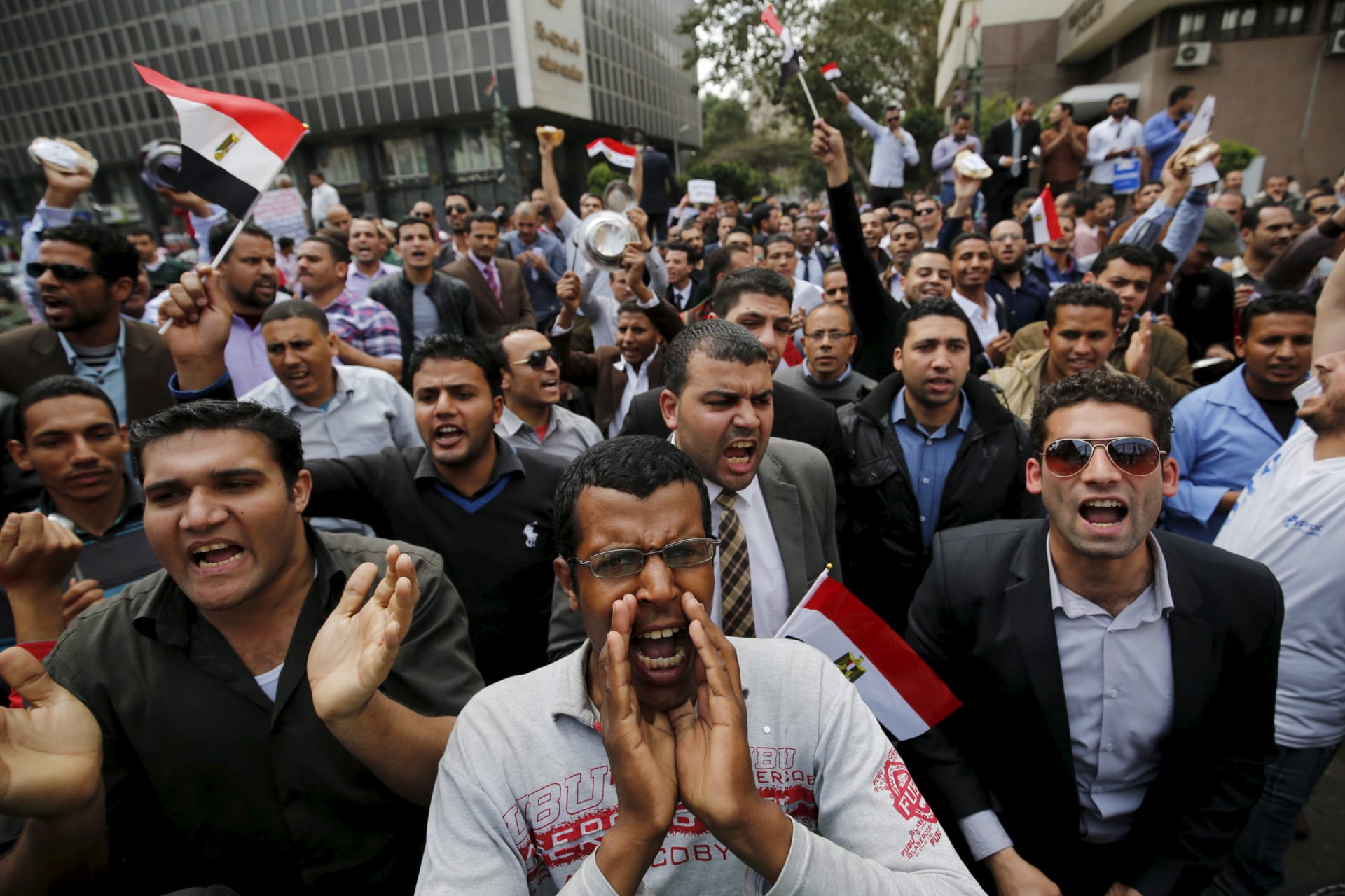 <p>Unemployed graduates shout anti-government slogans during a protest, to demand the government to offer them jobs, in front of the parliament headquarters in Cairo, March 27, 2016, where Egyptian Prime Minister Sherif Ismail was speaking</p>
