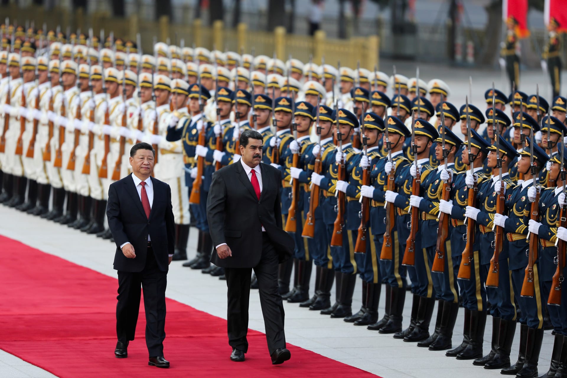<p>Chinese President Xi Jinping walks next to Venezuela’s President Nicolas Maduro during his welcoming ceremony in Beijing on September 14, 2018.</p>
