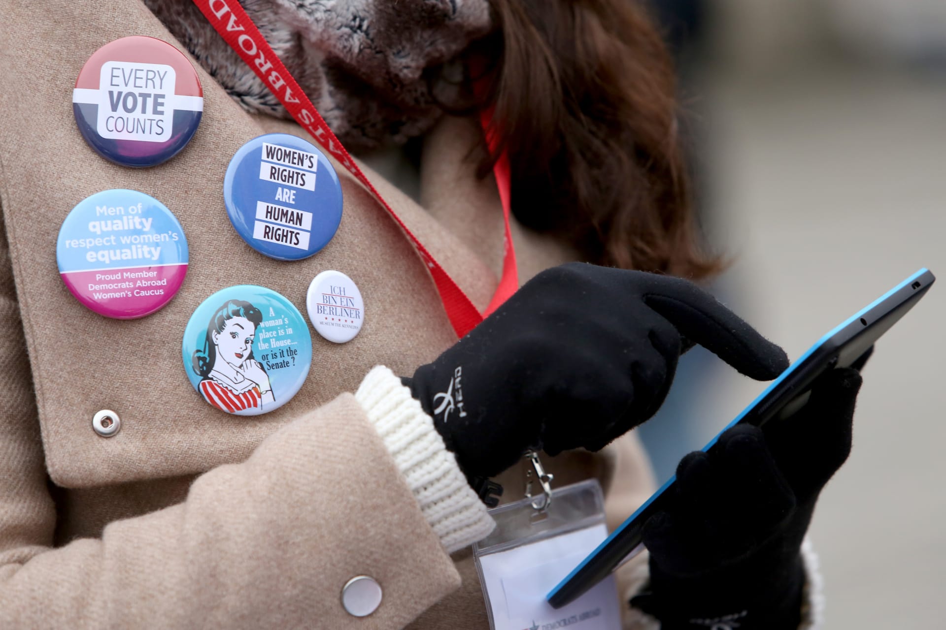<p>An activist uses a mobile phone as she participates in a demonstration for women’s rights on January 21, 2018.</p>
