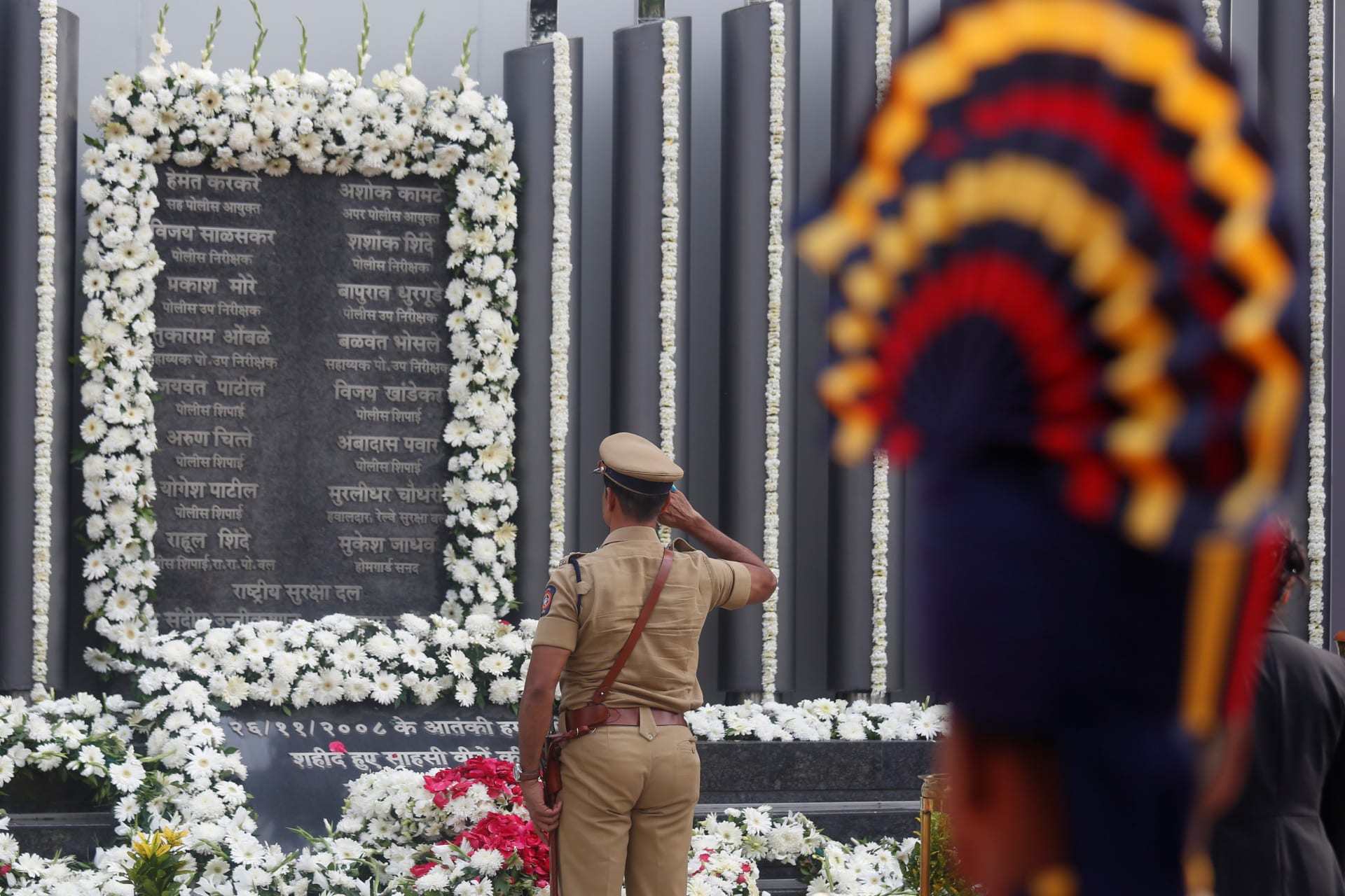 <p>A policeman pays his respects at a memorial to mark the tenth anniversary of the November 26, 2008 attacks in Mumbai, India.</p>
