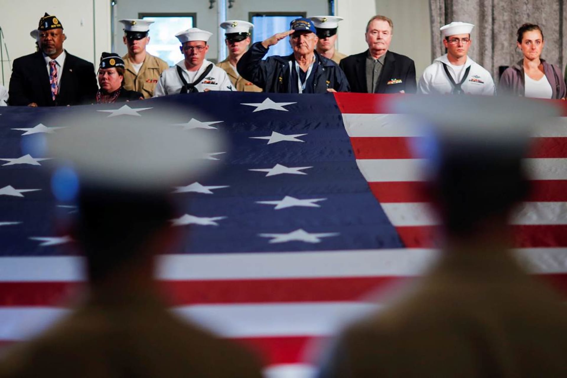 <p>U.S. service members hold the U.S. flag at ceremony honoring the men and women who died while serving in the U.S. Armed Forces.</p>
