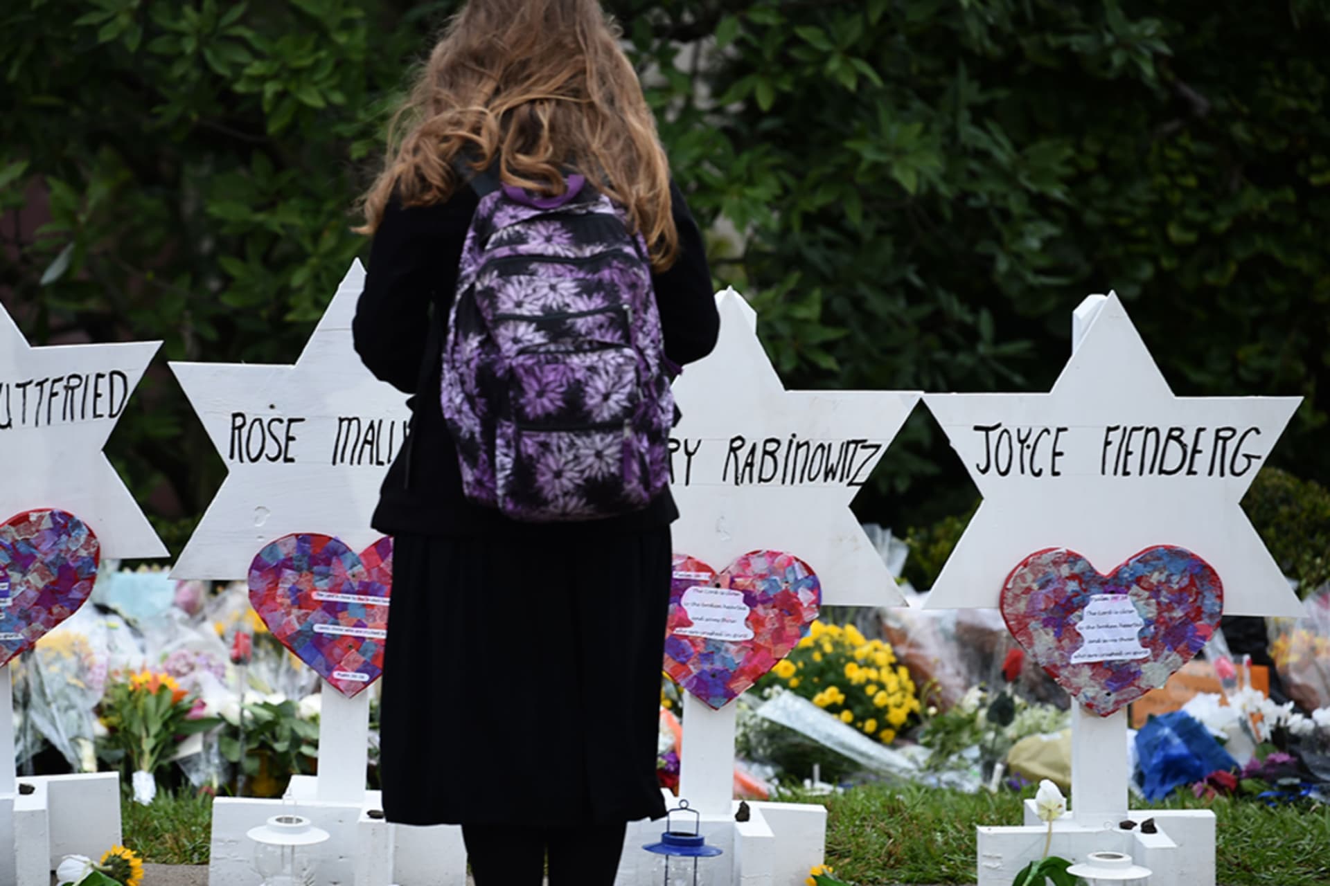 <p>A woman stands at a memorial outside the Tree of Life synagogue after a shooting there left 11 people dead in the Squirrel Hill neighborhood of Pittsburgh on October 27, 2018.</p>
