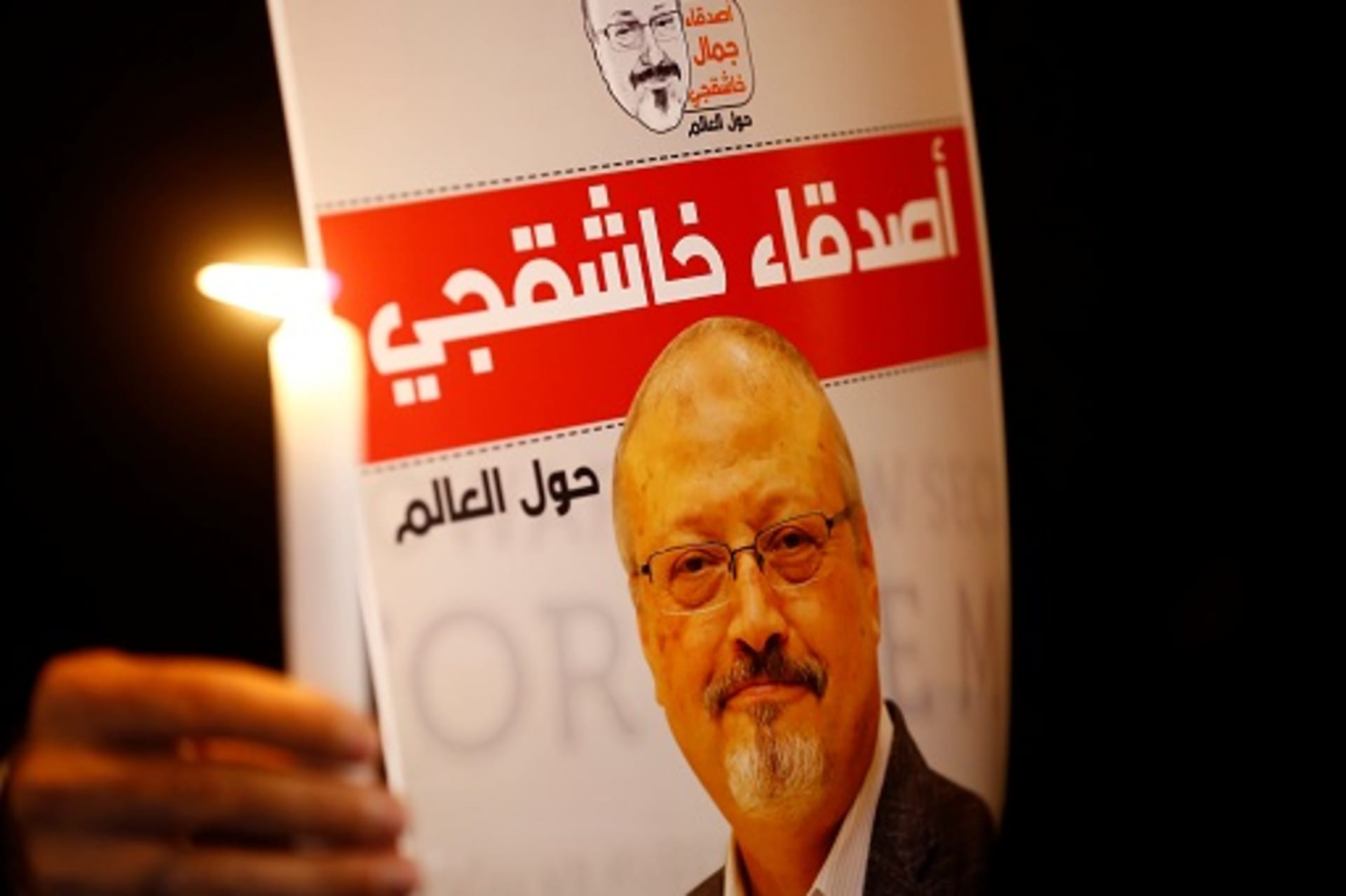 <p>A demonstrator holds a poster with a picture of Saudi journalist Jamal Khashoggi. </p>
