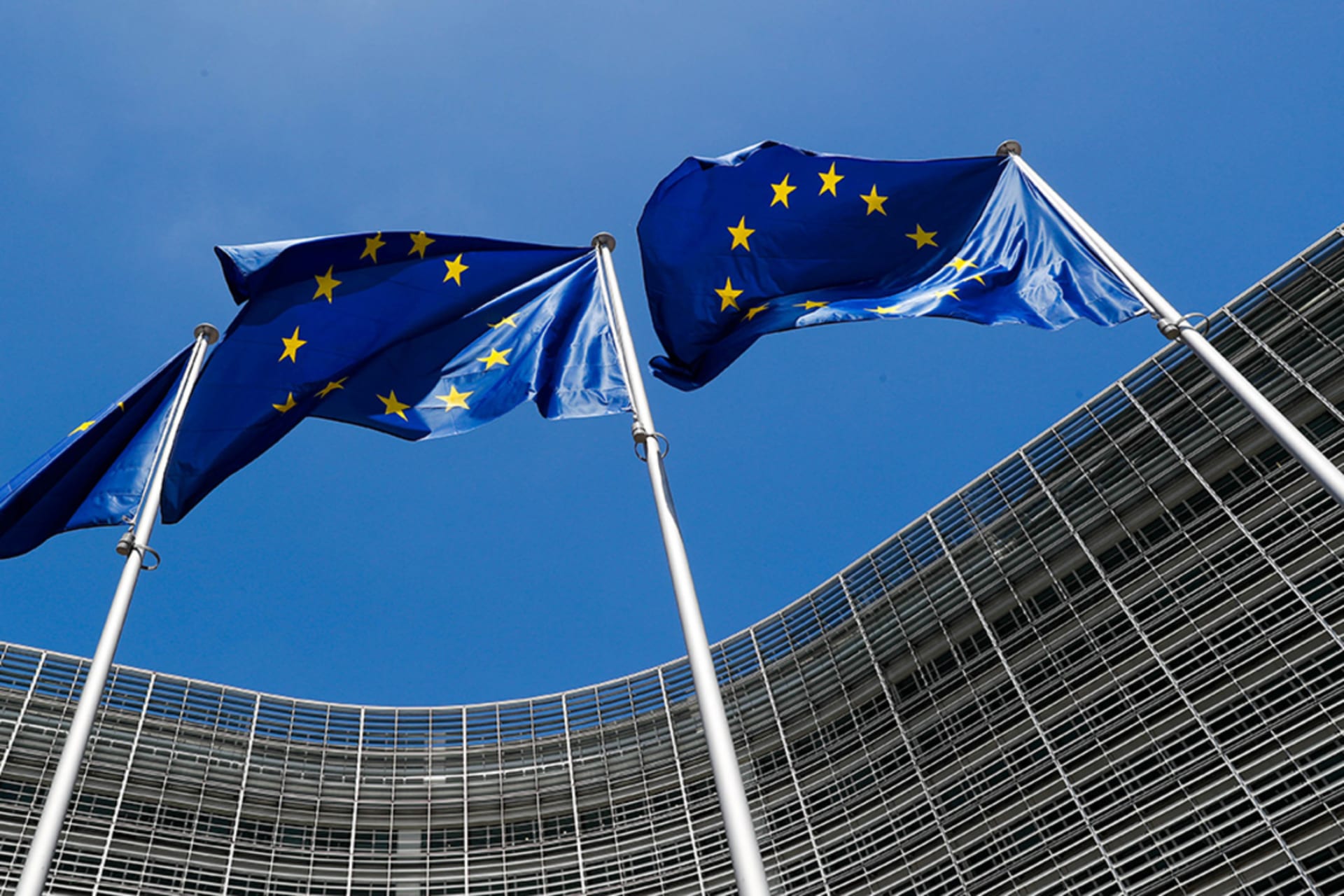 <p>European Union flags fly in 2018 outside the European Commission headquarters in Brussels, Belgium. Brussels effectively serves as the EU’s capital.</p>
