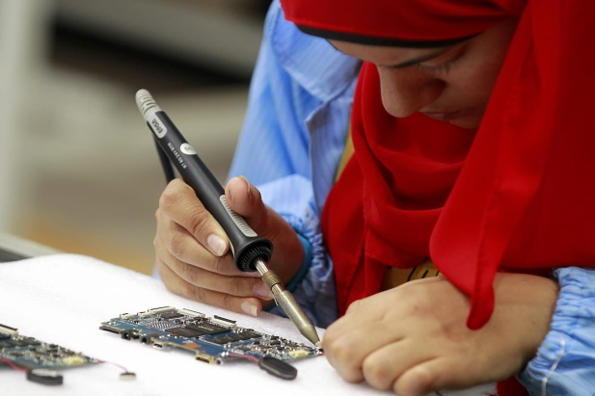 <p>A worker during the manufacturing process for a tablet computer at a factory in Egypt.</p>
