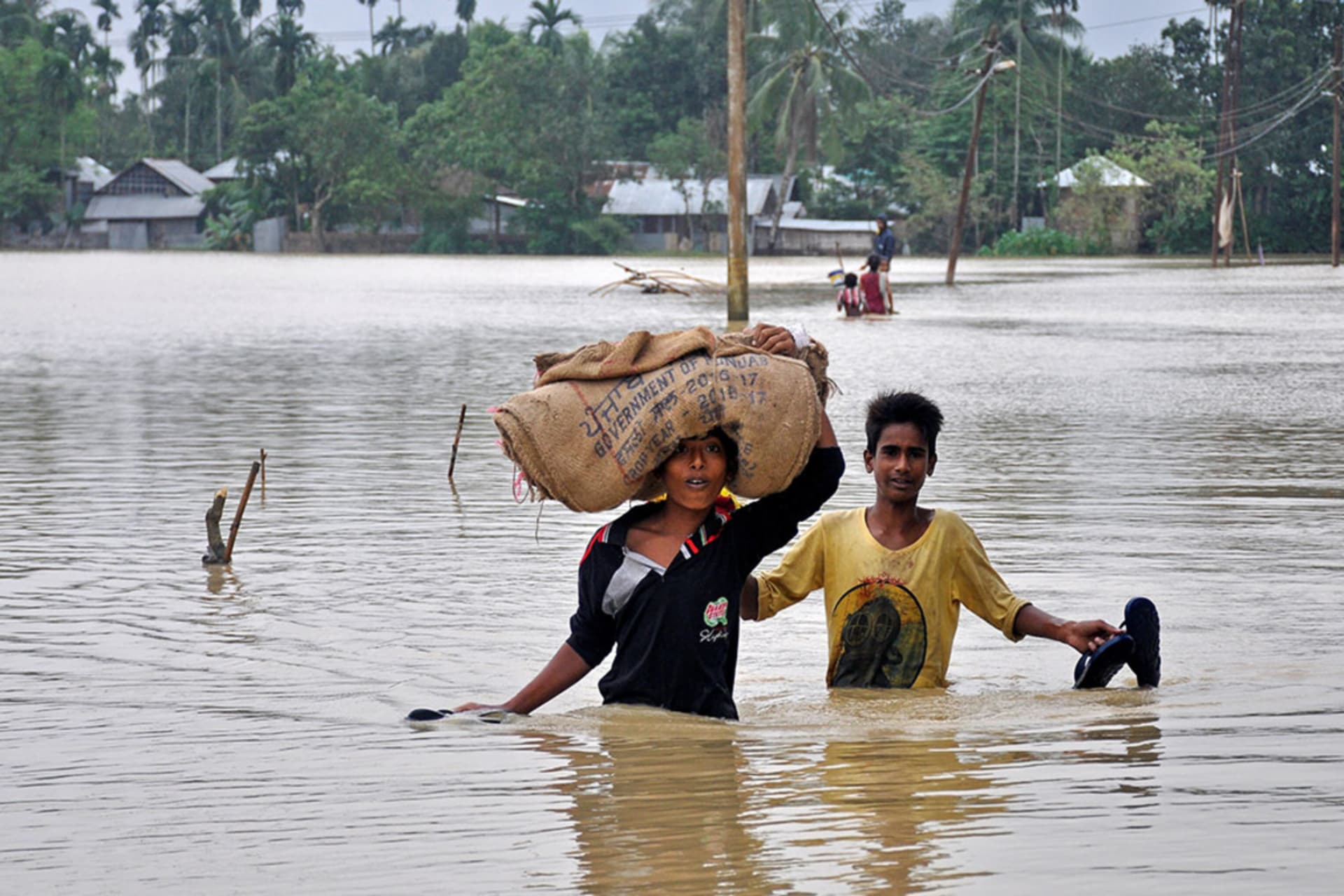 <p>Boys wade through a flooded village on the outskirts of Agartala, India, October 22, 2017.</p>
