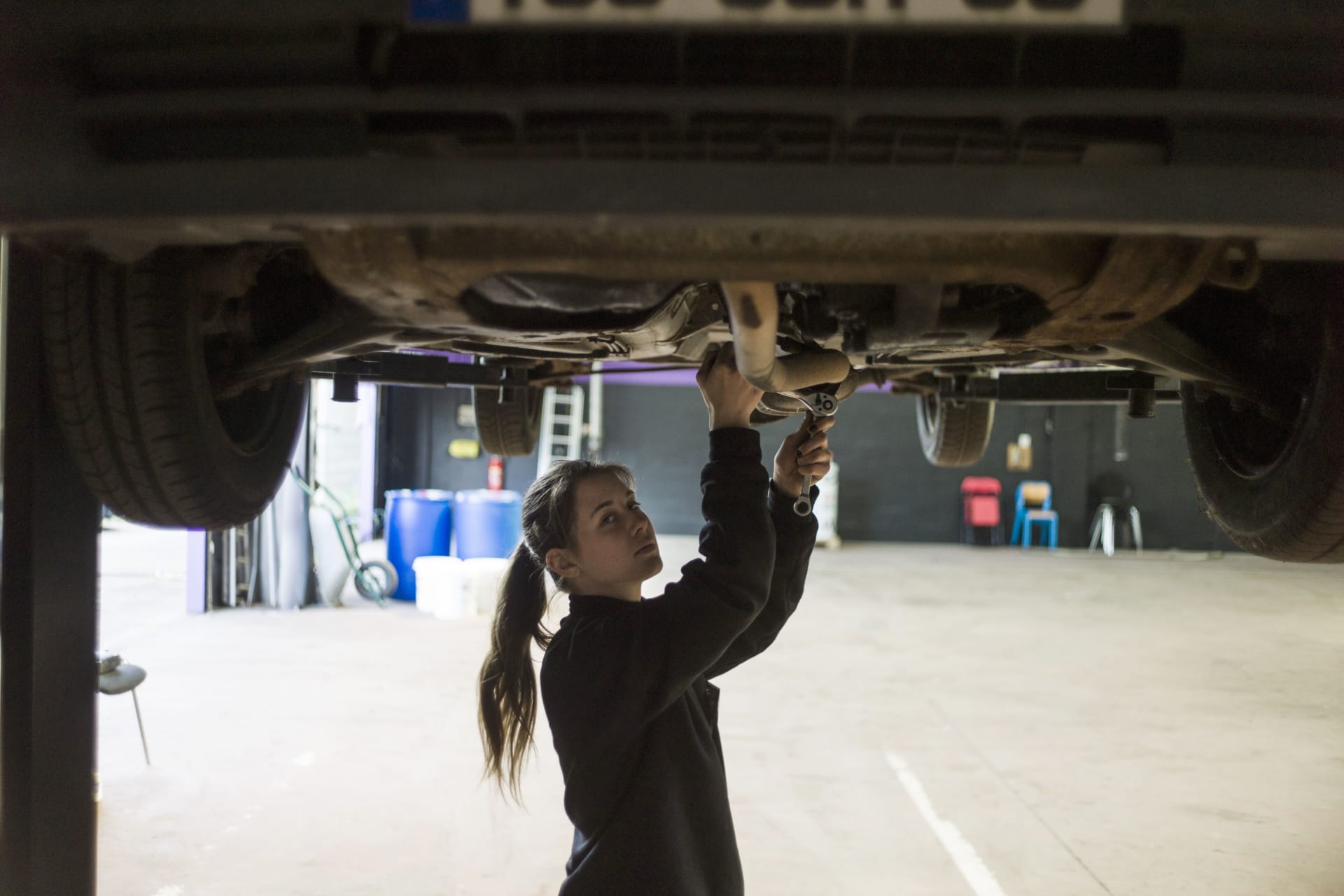 <p>A woman mechanic works on a car in an innovative garage and auto repair workshop that is catering exclusively to female customers, in Saint-Ouen-l’Aumone, in the suburbs of Paris. May 14, 2014. </p>