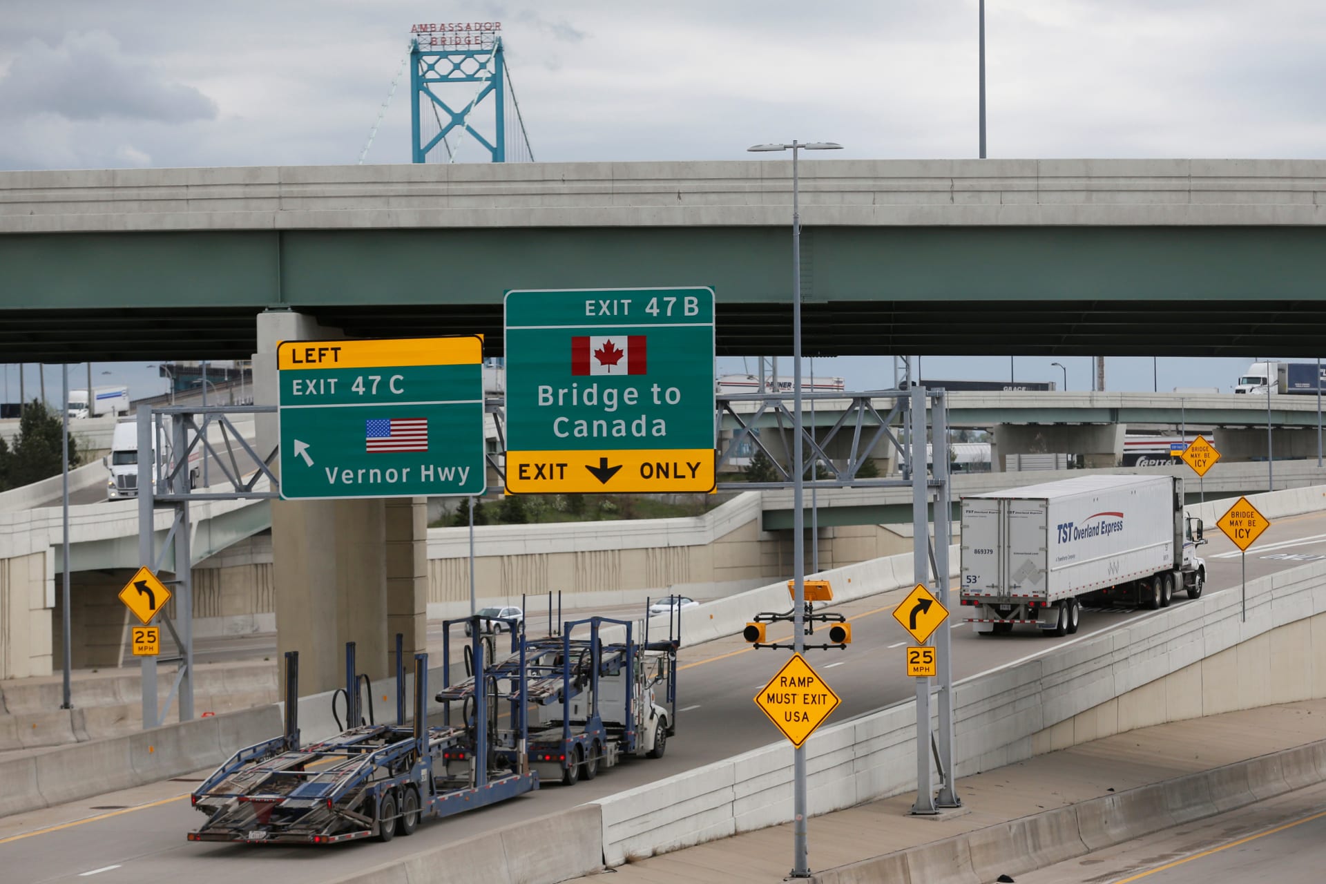 <p>Semi trucks headed for Windsor, Ontario, exit onto the lane towards the Ambassador bridge in Detroit, Michigan on April 26, 2017.</p>
