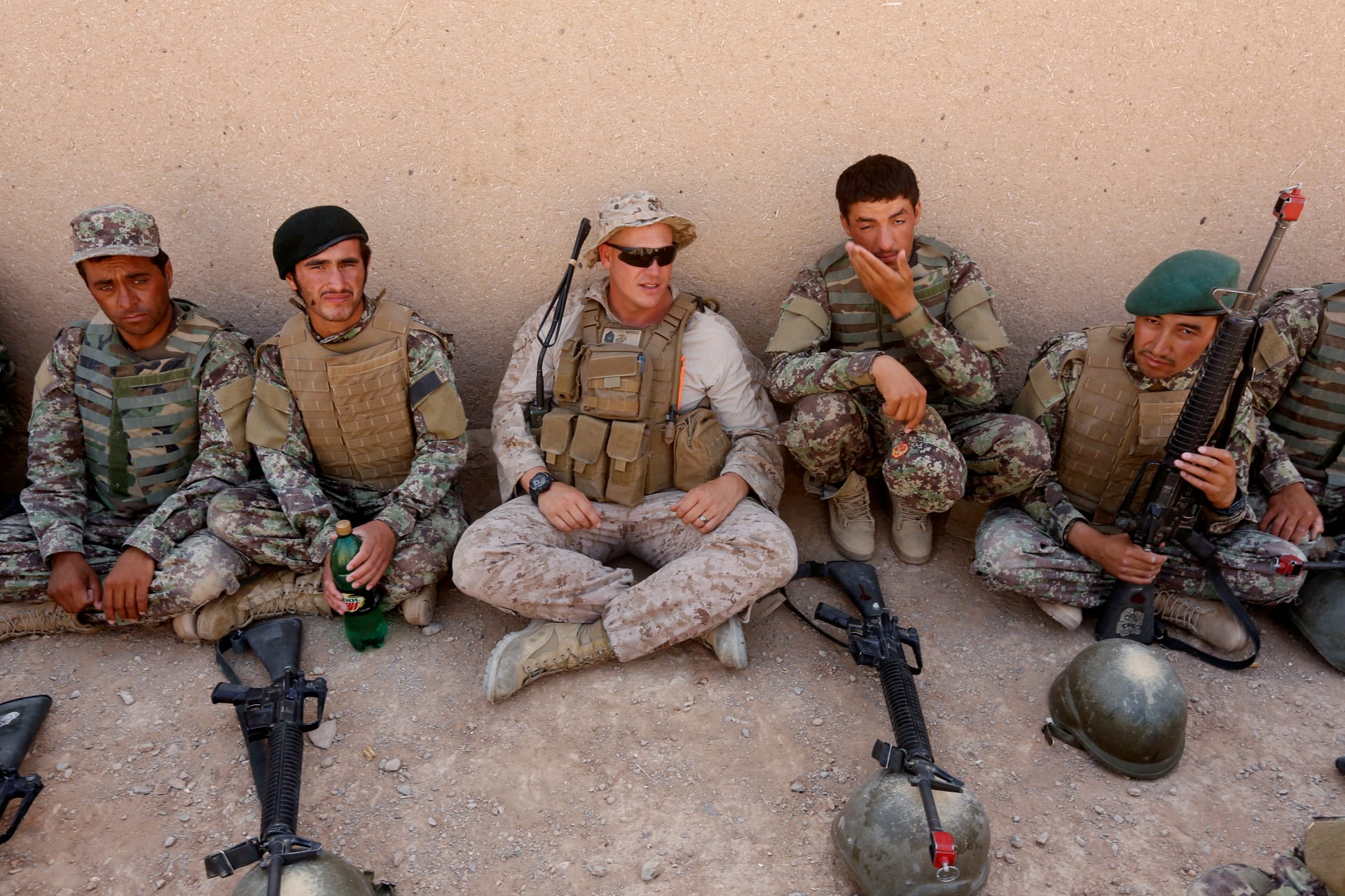 <p>A U.S. Marine talks with Afghan National Army soldiers during a training in Helmand province, Afghanistan.</p>
