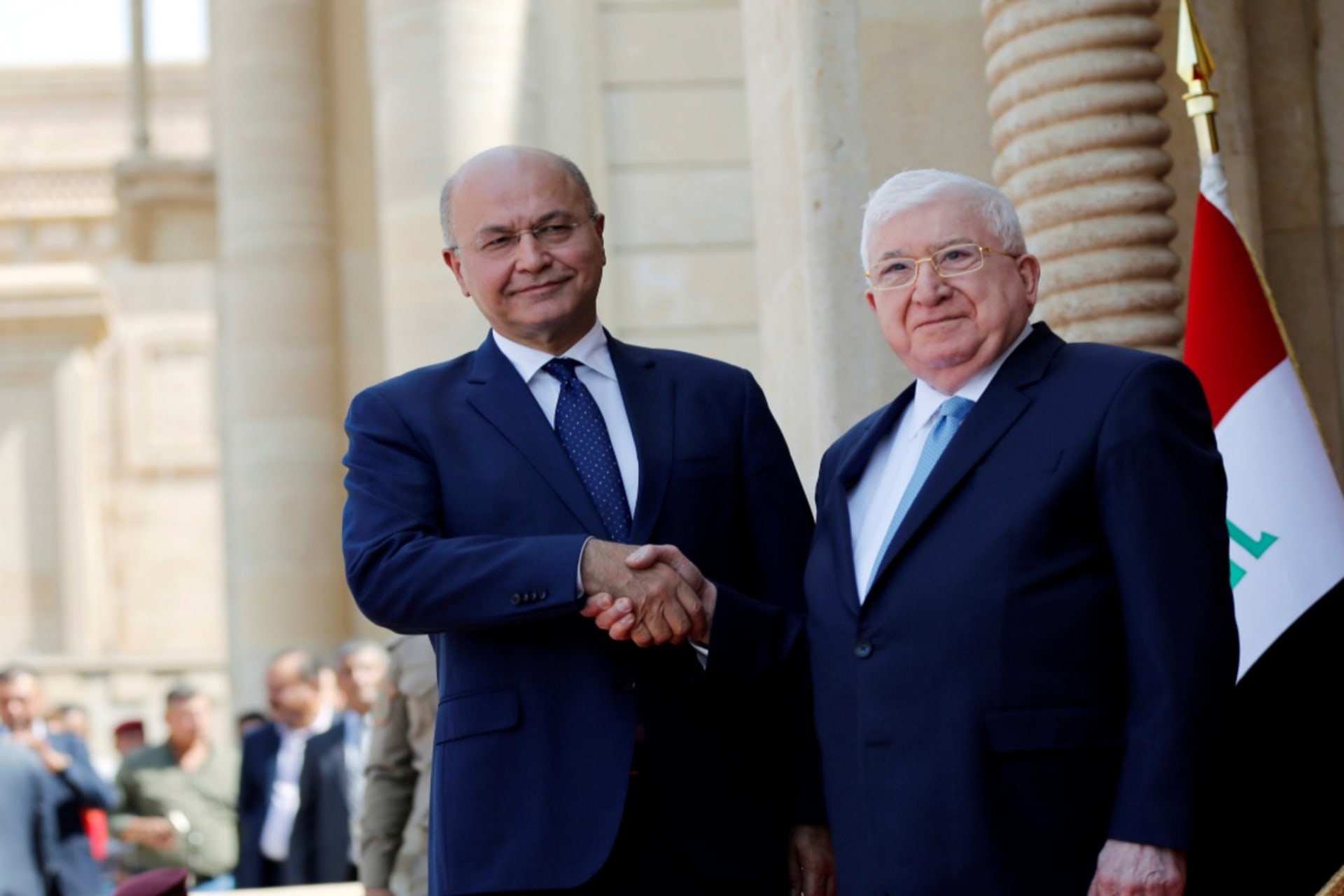 <p>Iraq’s outgoing President Fuad Masum and newly elected President Barham Salih shake hands at a ceremony held at Salam Palace in Baghdad, Iraq, on October 3, 2018. </p>
