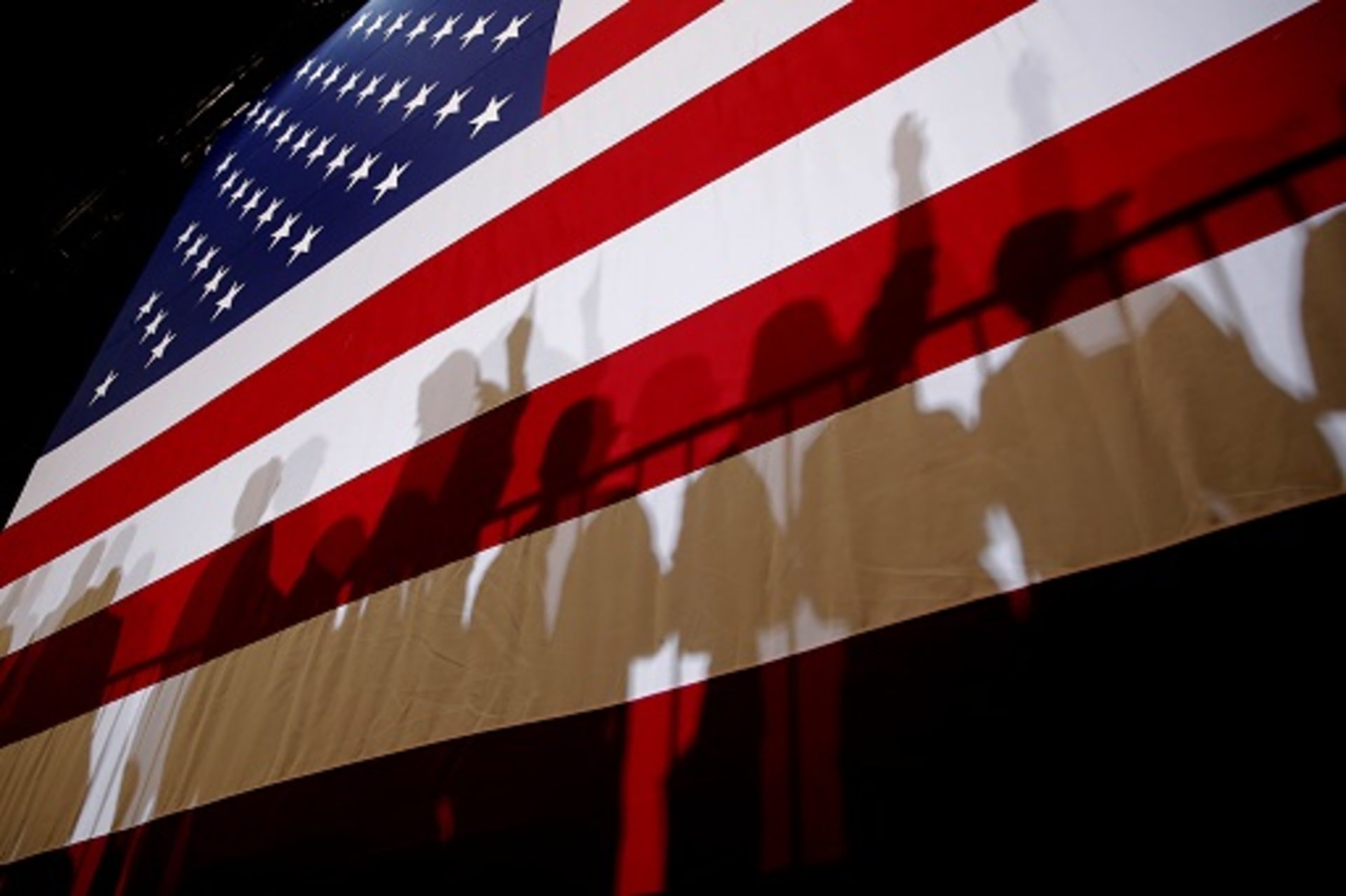 <p>Shadows are seen on an American Flag. </p>