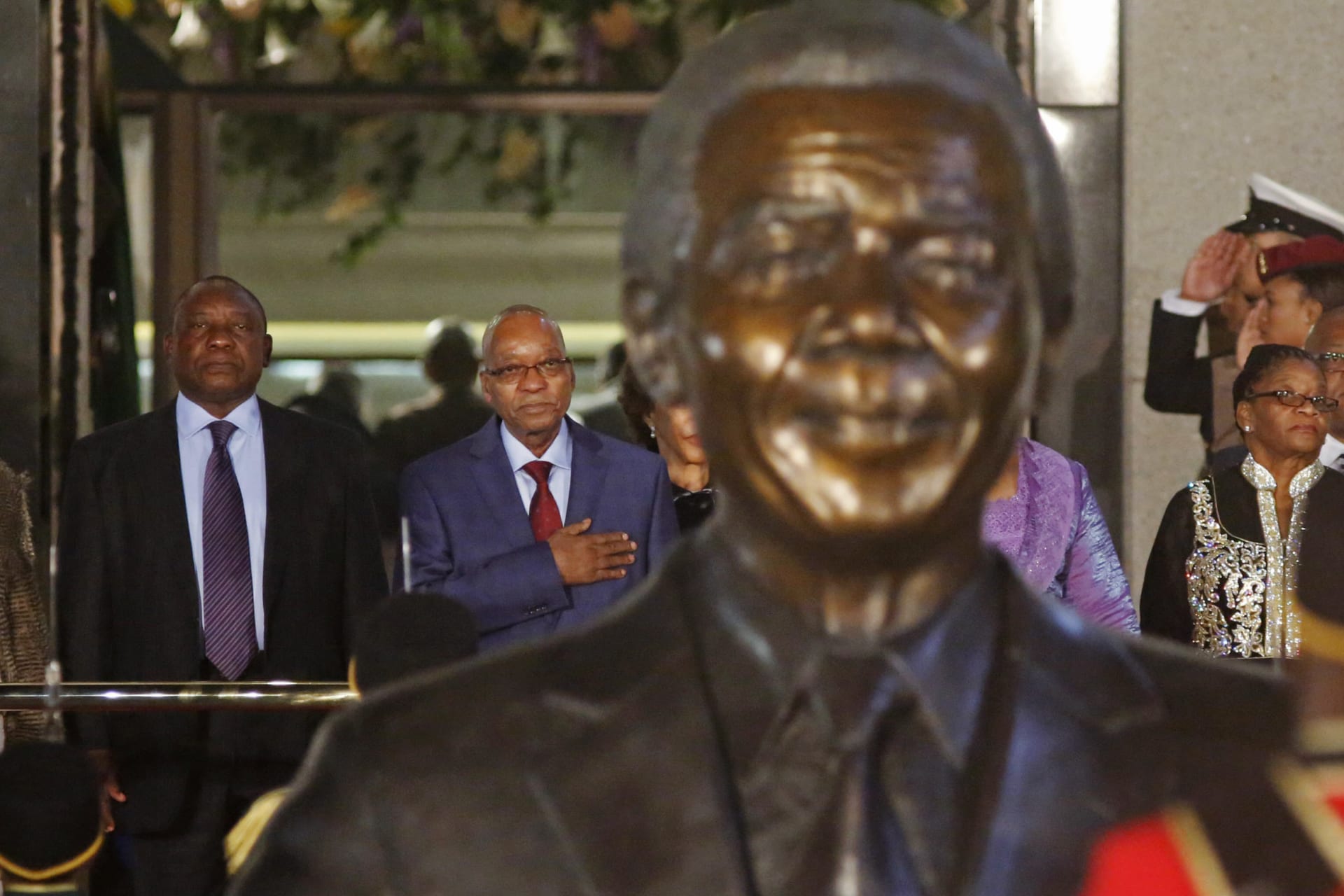 <p>Jacob Zuma, president of South Africa at the time, stands with then-vice president and current President Cyril Ramaphosa behind a statue of former South African President Nelson Mandela outside Parliament in Cape Town on June 17, 2014.</p>
