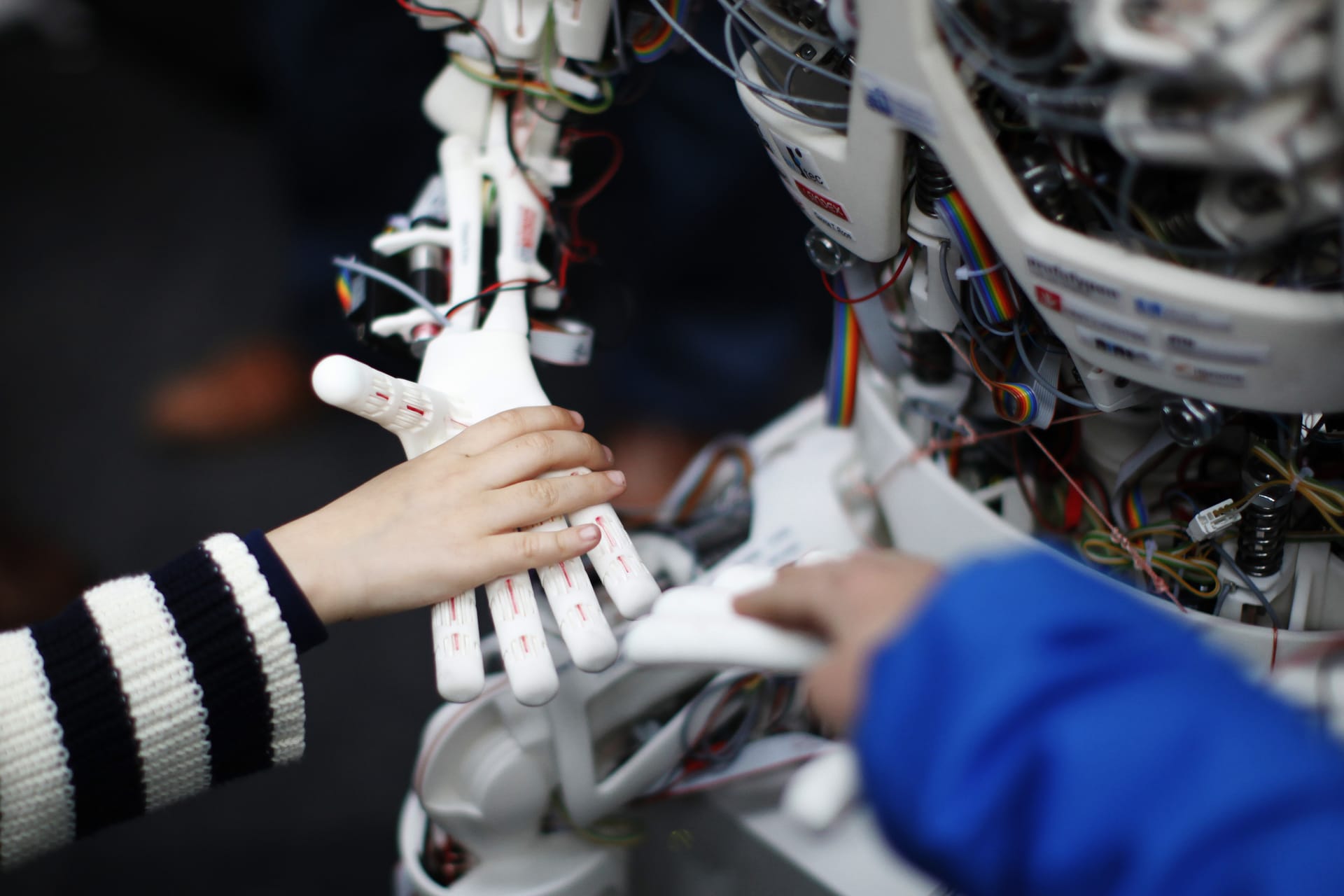 <p>Children touch the hands of the humanoid robot Roboy at the exhibition Robots on Tour in Zurich on March 9, 2013. </p>
