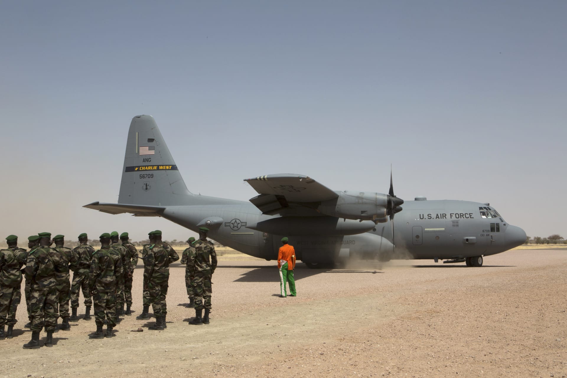 <p>A C-130 U.S. Air Force plane lands as Nigerien soldiers stand in formation during the Flintlock military exercise in Diffa, March 8, 2014.</p>
