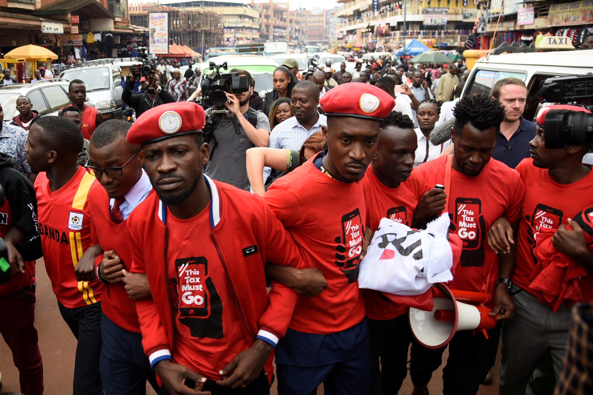 <p>Ugandan musician turned politician, Robert Kyagulanyi (C), also known as Bobi Wine, leads activists during a demonstration against new taxes including a levy on access to social media platforms in Kampala, Uganda July 11, 2018.</p>
