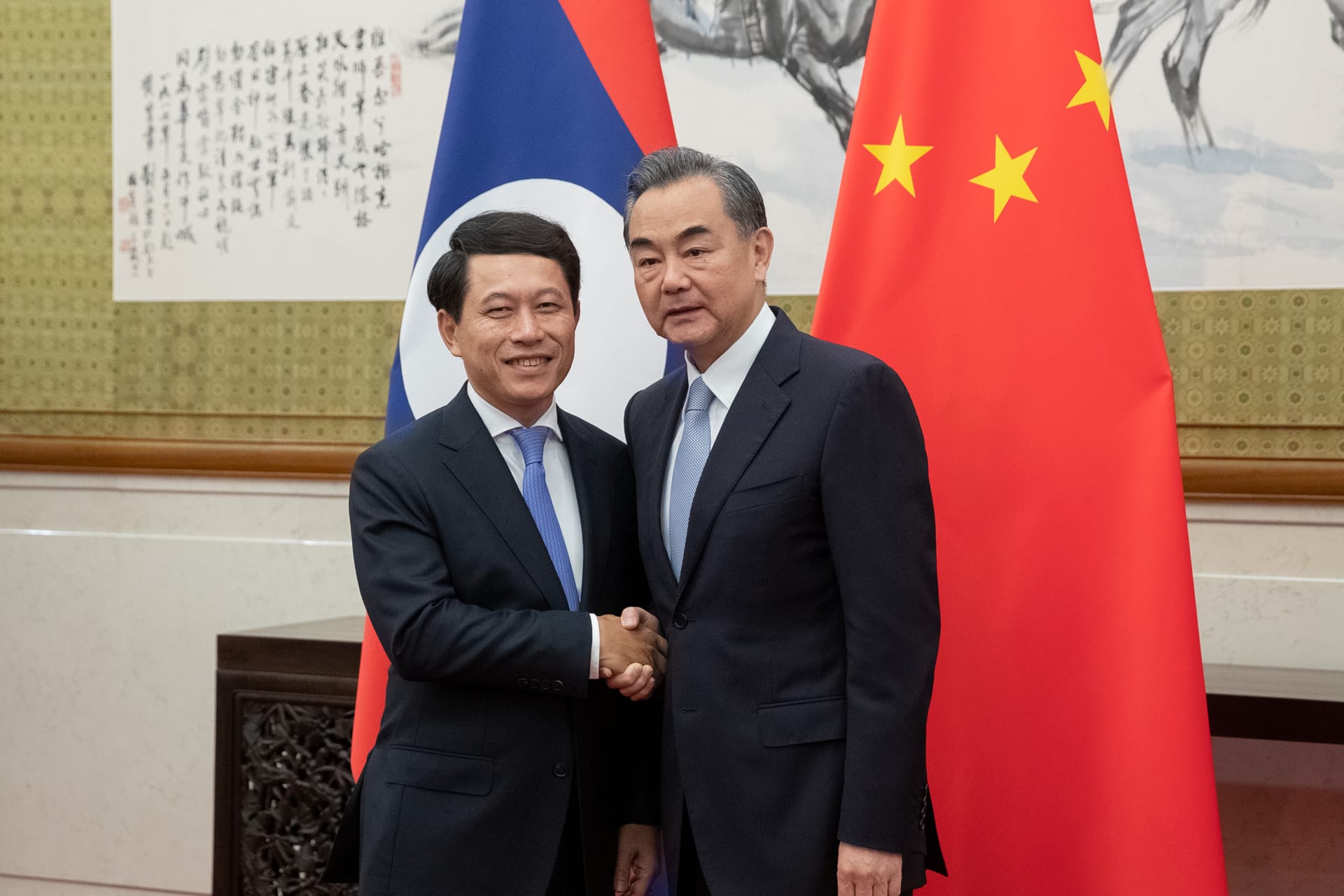 <p>Chinese Foreign Minister Wang Yi and his counterpart from Laos, Saleumxay Kommasith, shake hands at Diaoyutai State Guesthouse in Beijing, China on August 26, 2018.</p>
