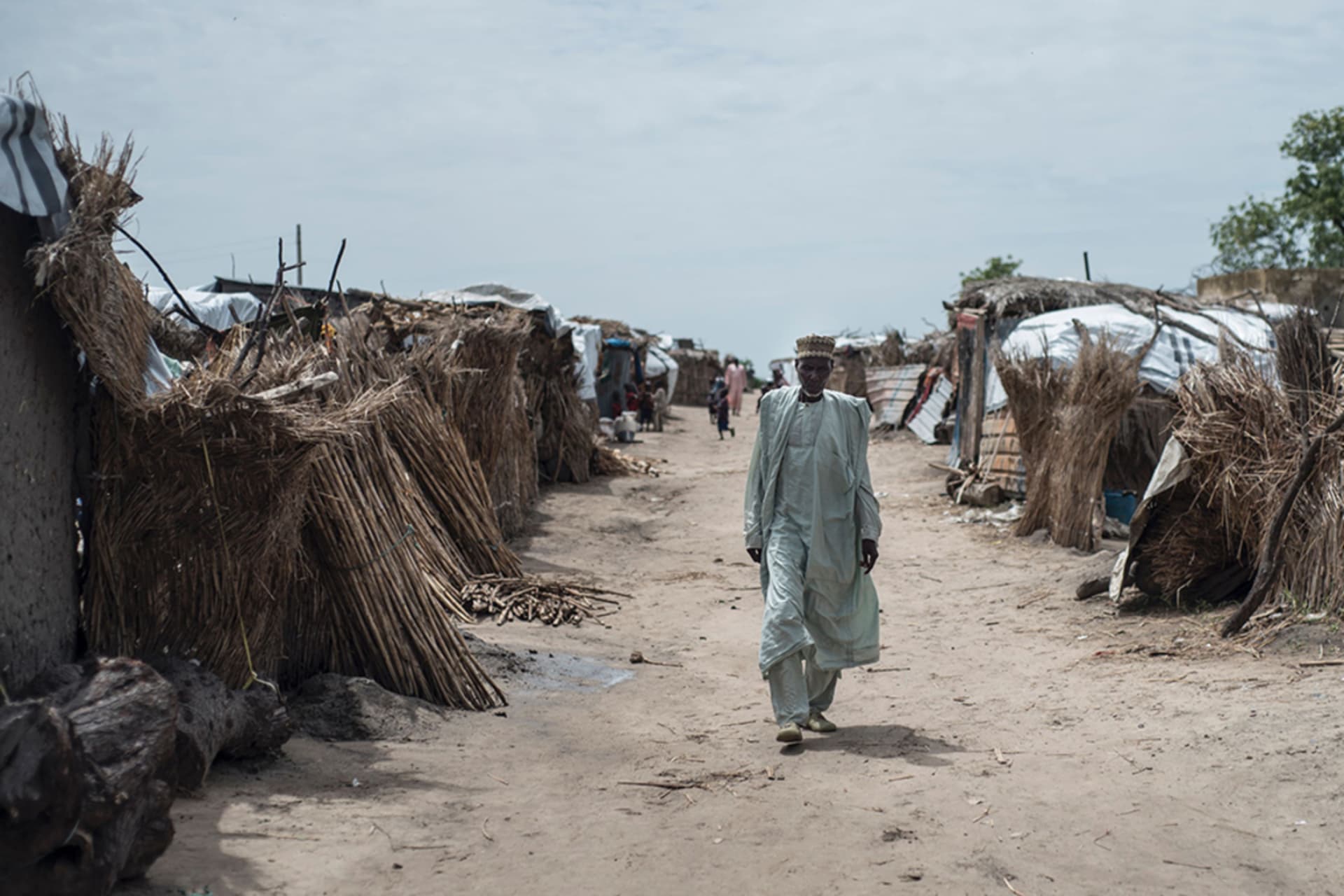 <p>A man walks through a camp for internally displaced people in Rann, Nigeria.</p>
