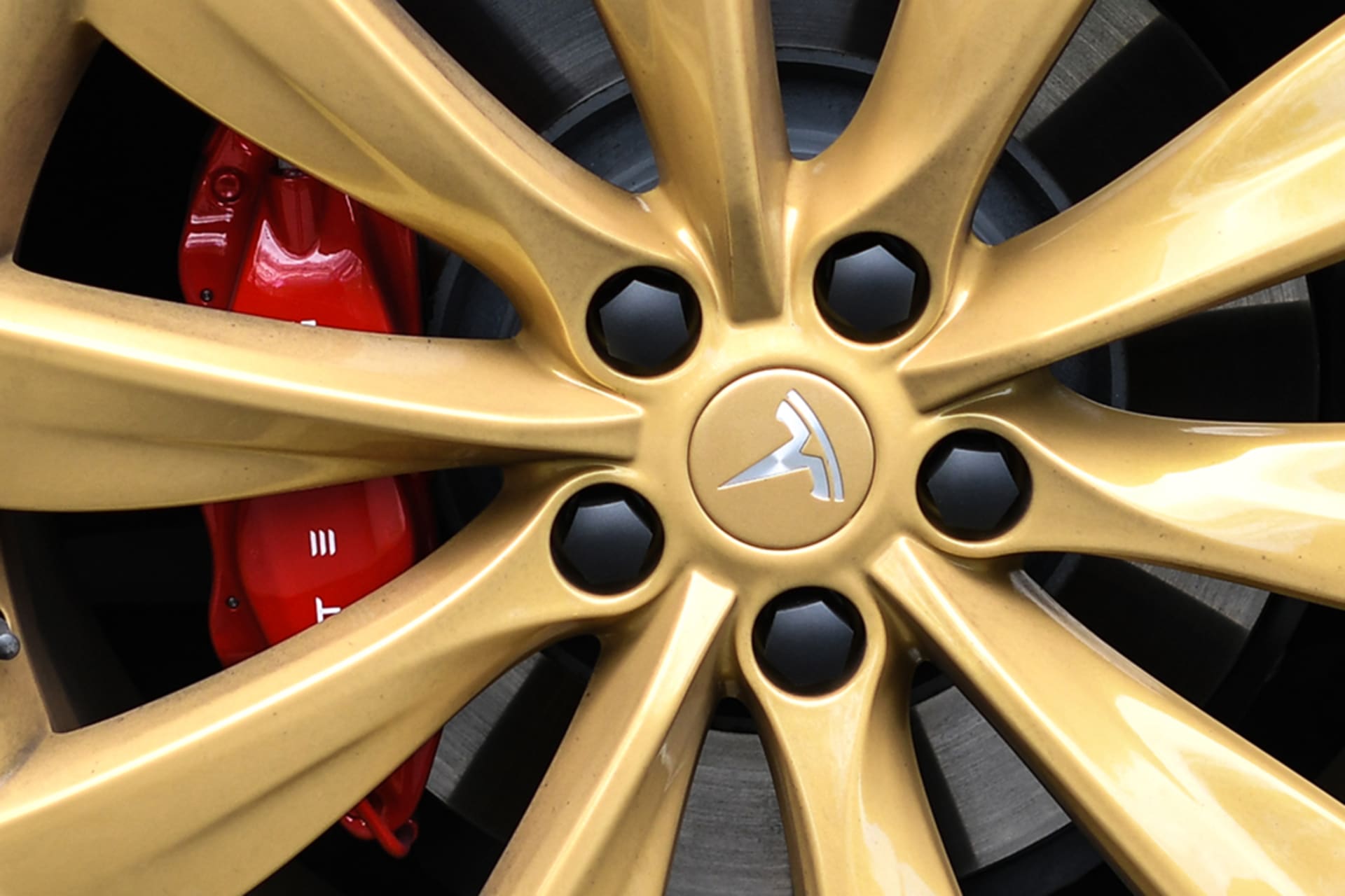 <p>A Tesla logo on the wheel of a Model S car at a launch event. </p>
