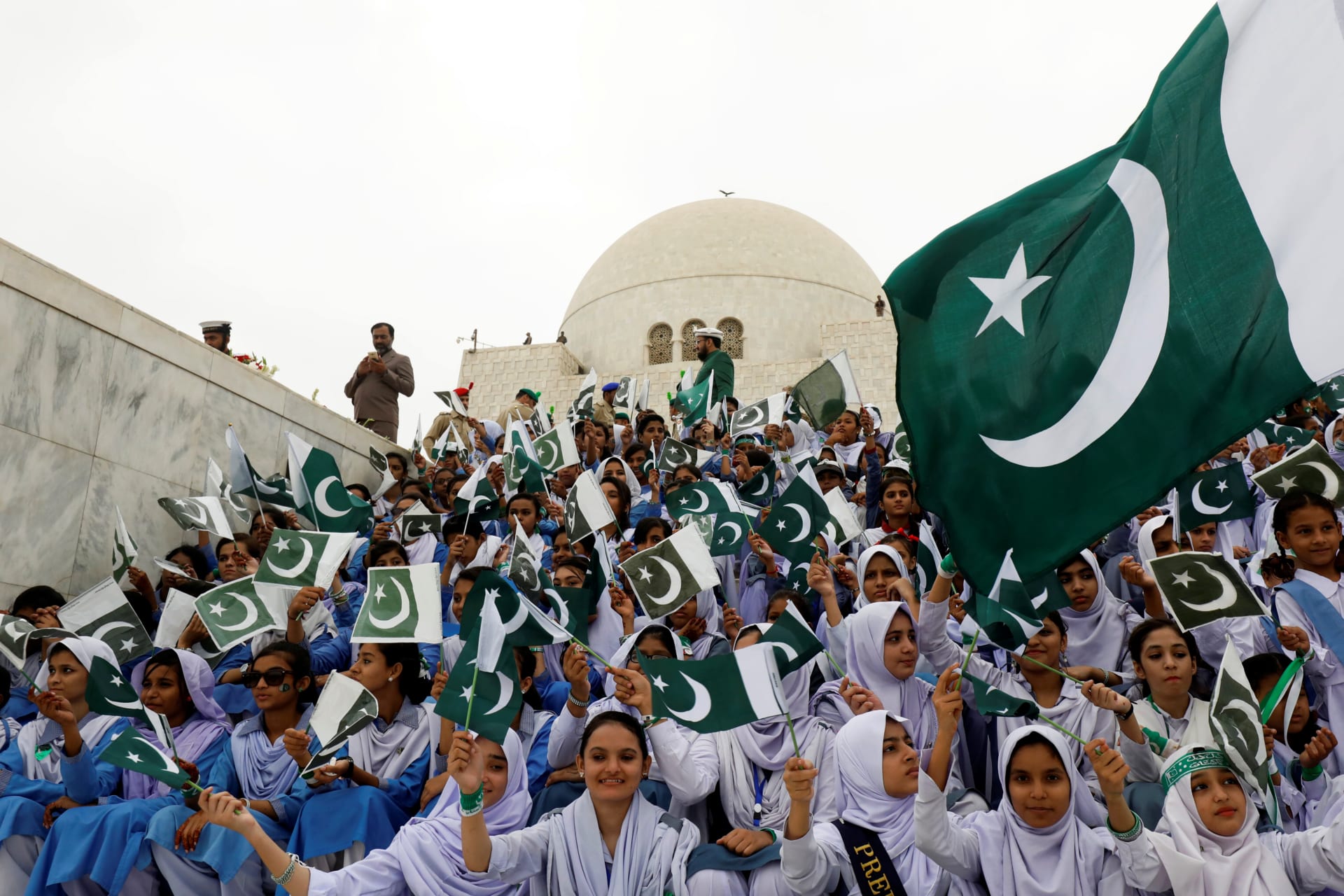 <p>Attendees wave Pakistan’s national flag while singing national songs at a ceremony to celebrate the country’s seventy-first independence day at the mausoleum of Muhammad Ali Jinnah in Karachi, Pakistan August 14, 2018. </p>
