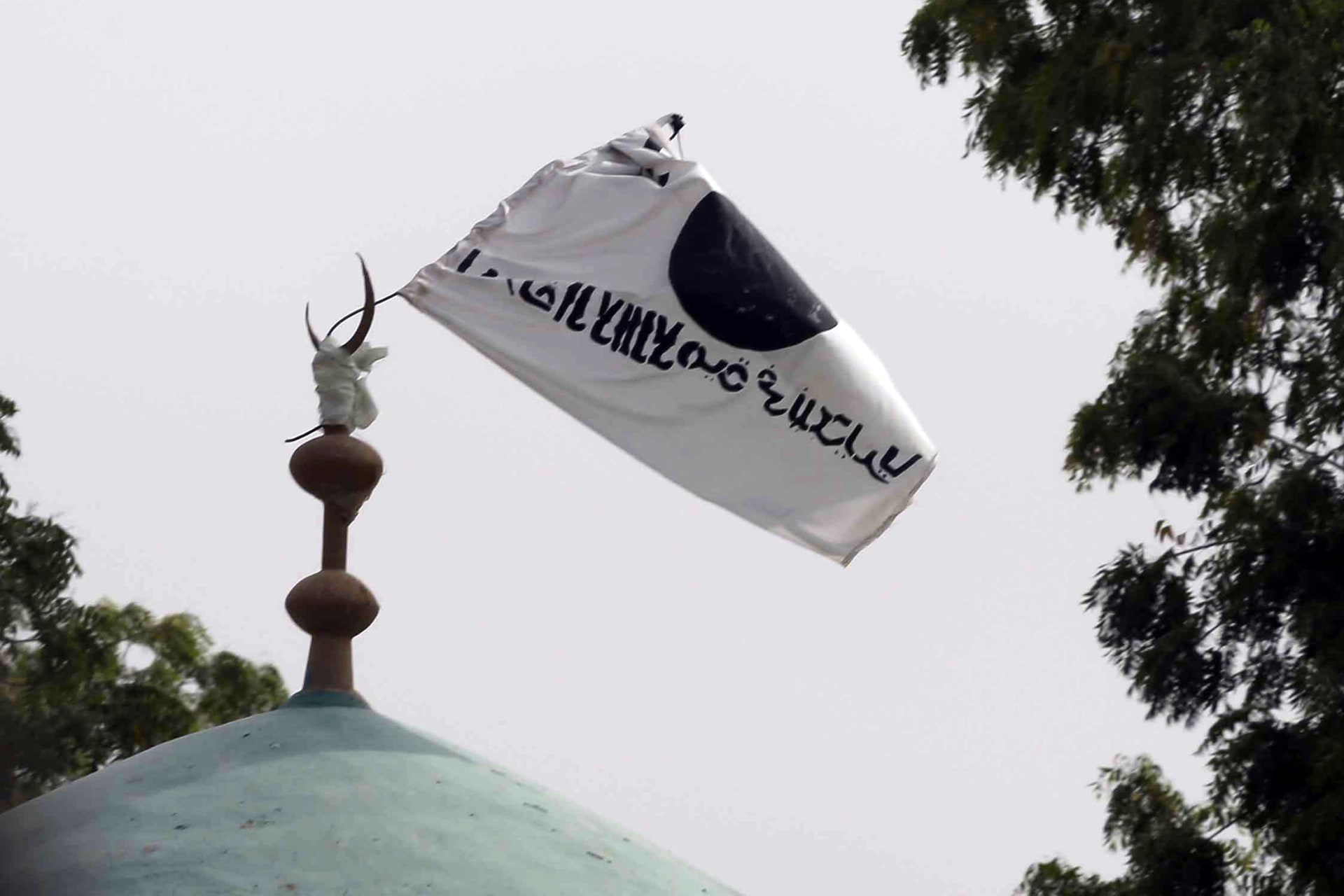 <p>A flag belonging to Boko Haram flies from a mosque in the retaken town of Damasak, Nigeria, March 18, 2015</p>
