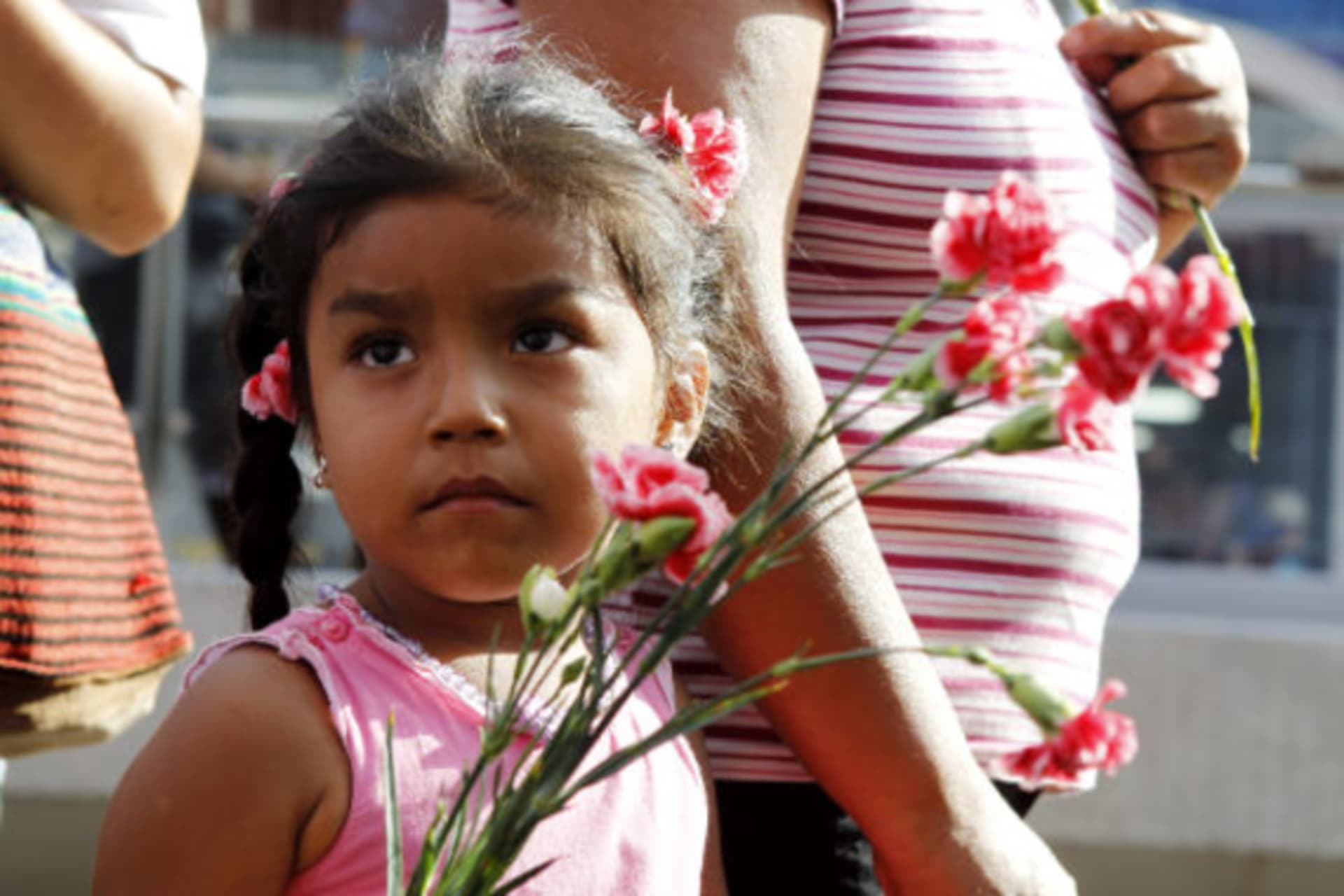 <p>A child holding flowers during International Women’s Day in Lima, March 8, 2011.</p>

