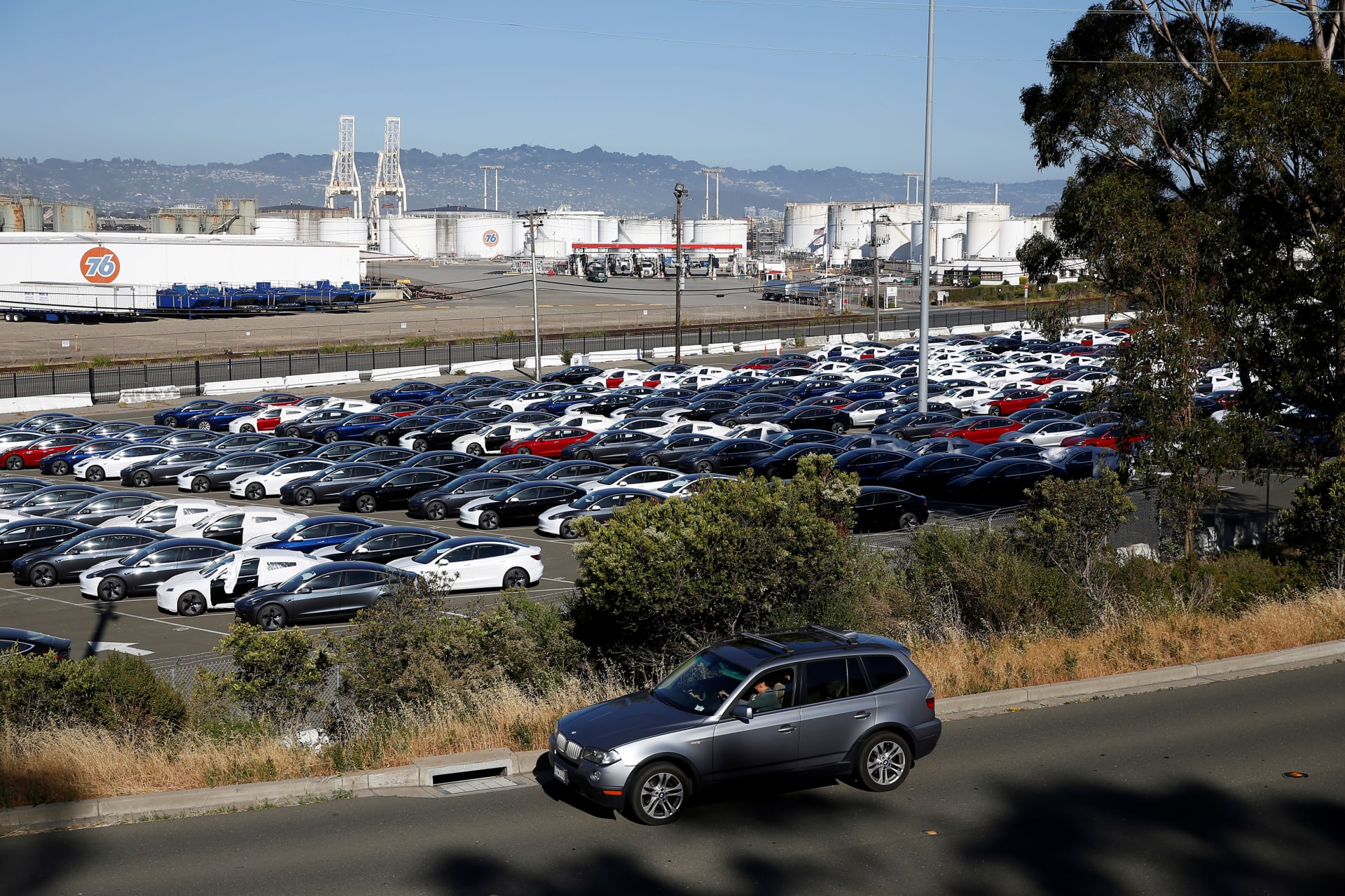 <p>A motorist drives past a parking lot full of new Tesla electric vehicles in Richmond, California, U.S. June 22, 2018.</p>
