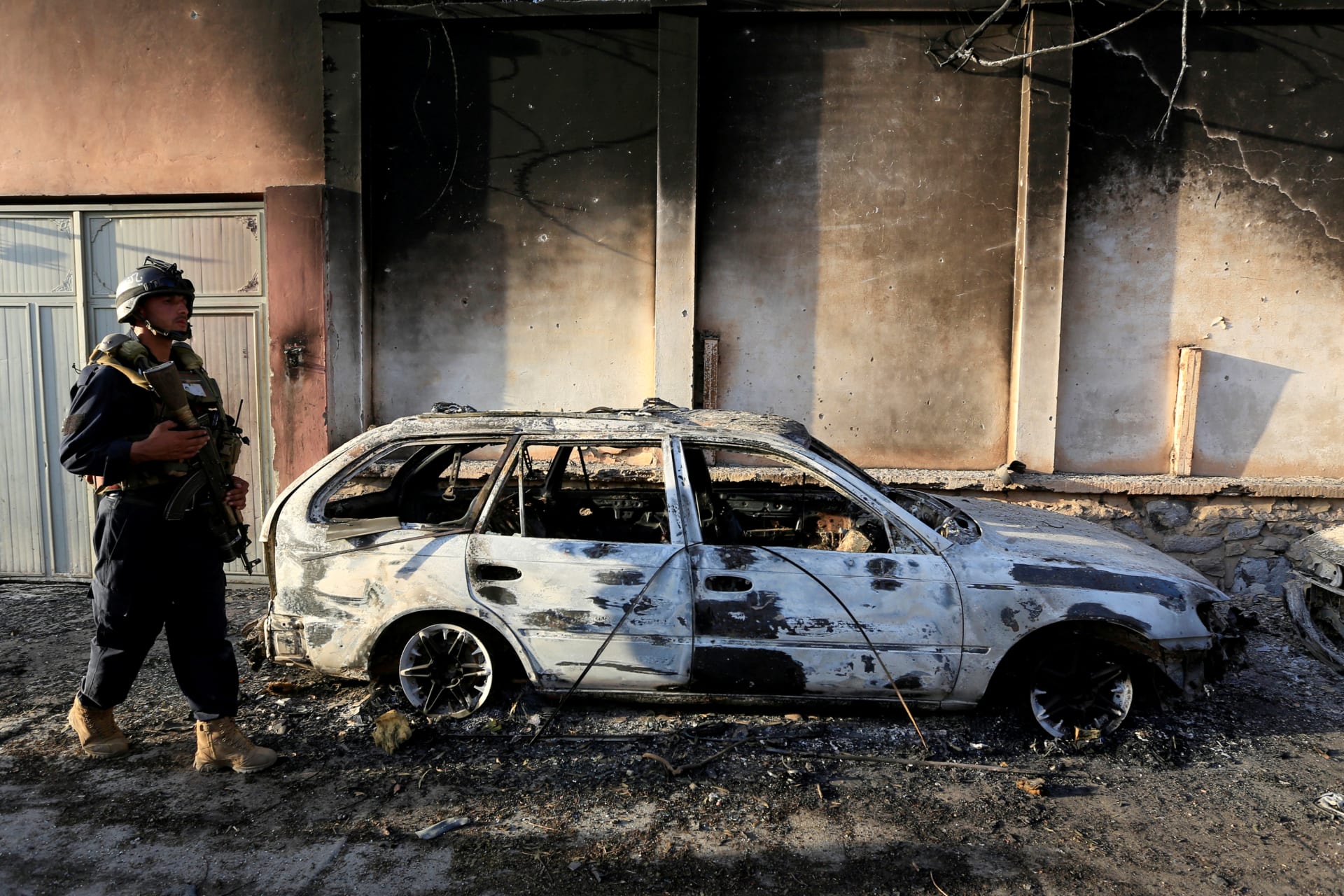 <p>An Afghan policeman inspects the site of an attack in Jalalabad, Afghanistan, on July 31, 2018.</p>
