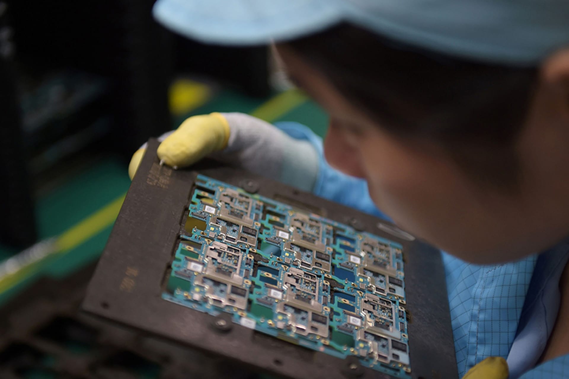 <p>A worker handles smartphone chip components at a factory in Dongguan, China.</p>
