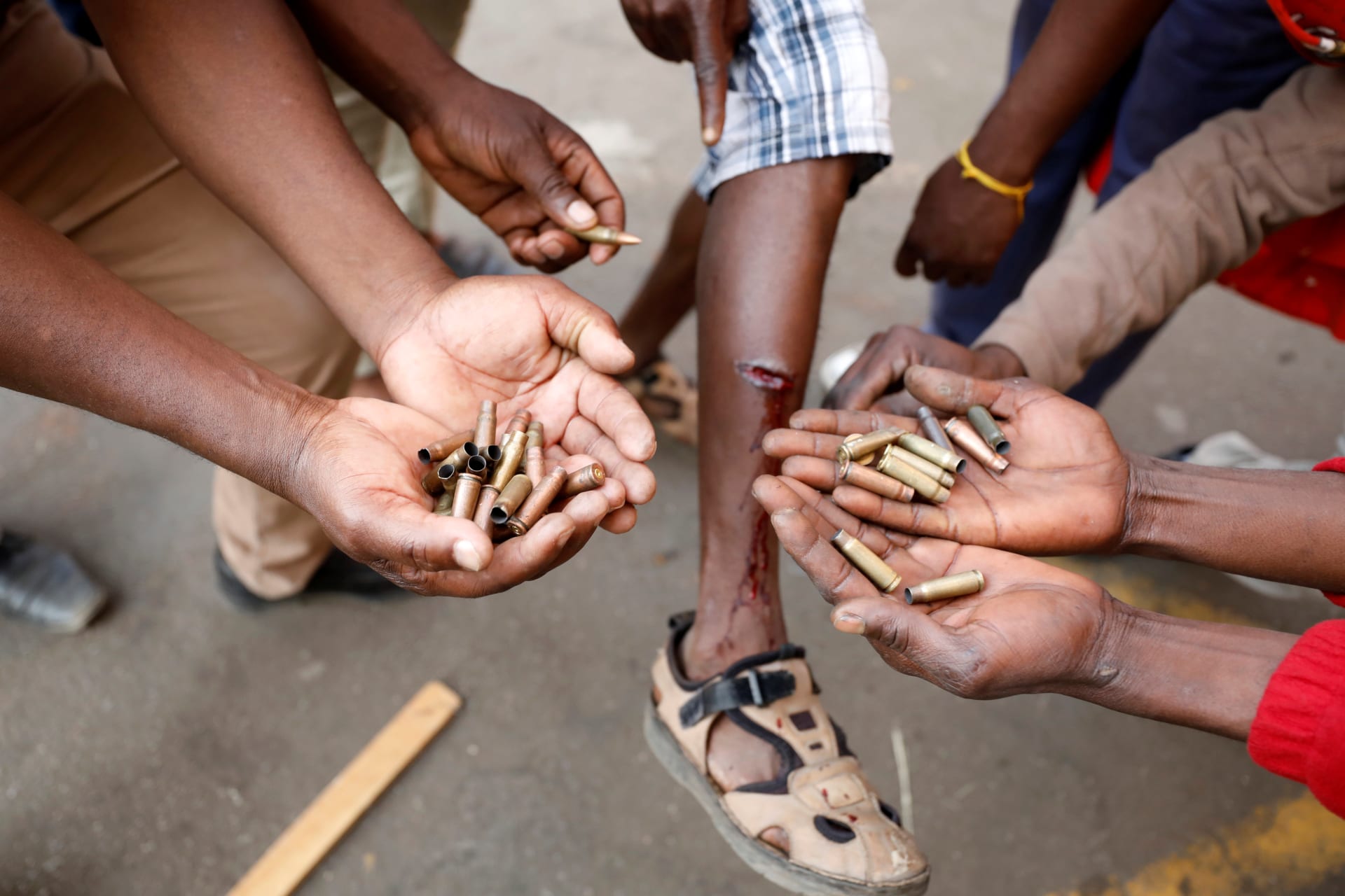 <p>Opposition Movement for Democratic Change supporters hold spent rounds and show injuries after soldiers opened fire outside the party’s headquarters in Harare, Zimbabwe, August 1, 2018.</p>
