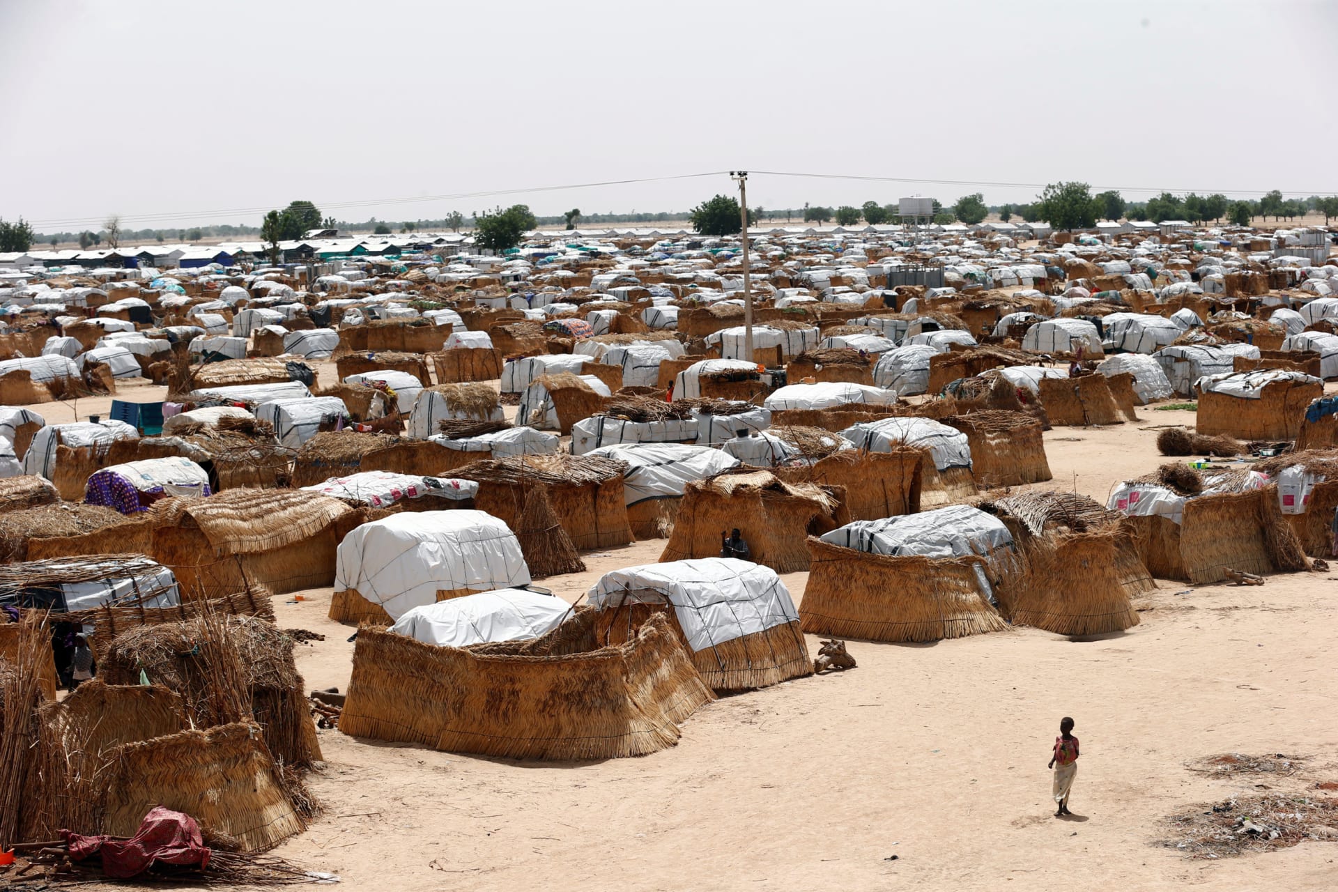 <p>A girl walks through makeshift sheds at an internally displaced persons (IDP) camp on the outskirts of Maiduguri, northeast Nigeria June 6, 2017. </p>
