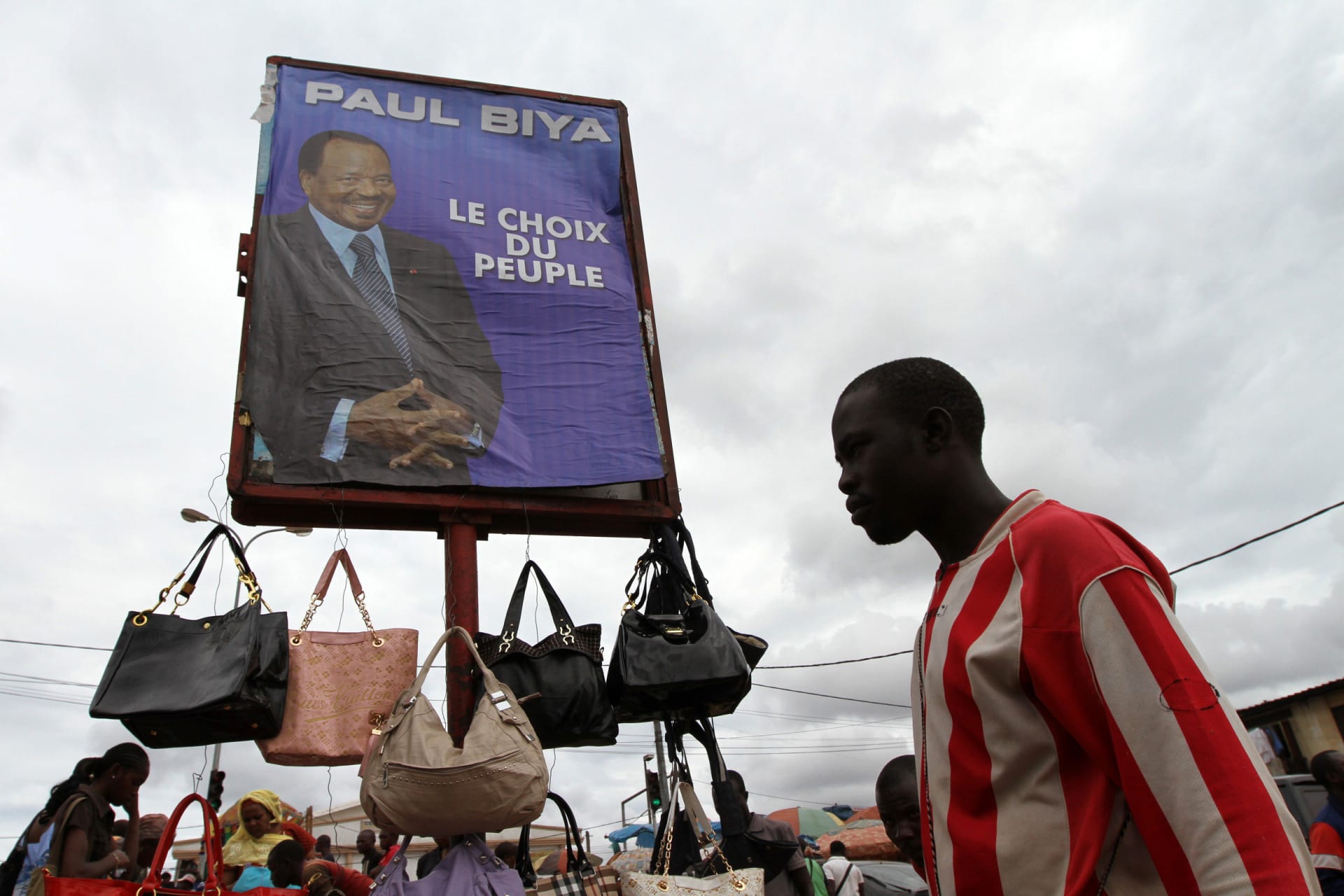 <p>A campaign billboard featuring Cameroon’s President Paul Biya is seen in the Makolo market a day before the country’s presidential election in Yaounde October 8, 2011.</p>
