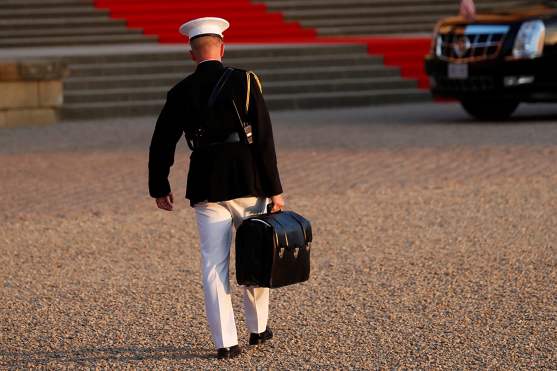 <p>A military aide carries the “football” containing launch codes for U.S. nuclear weapons.</p>
