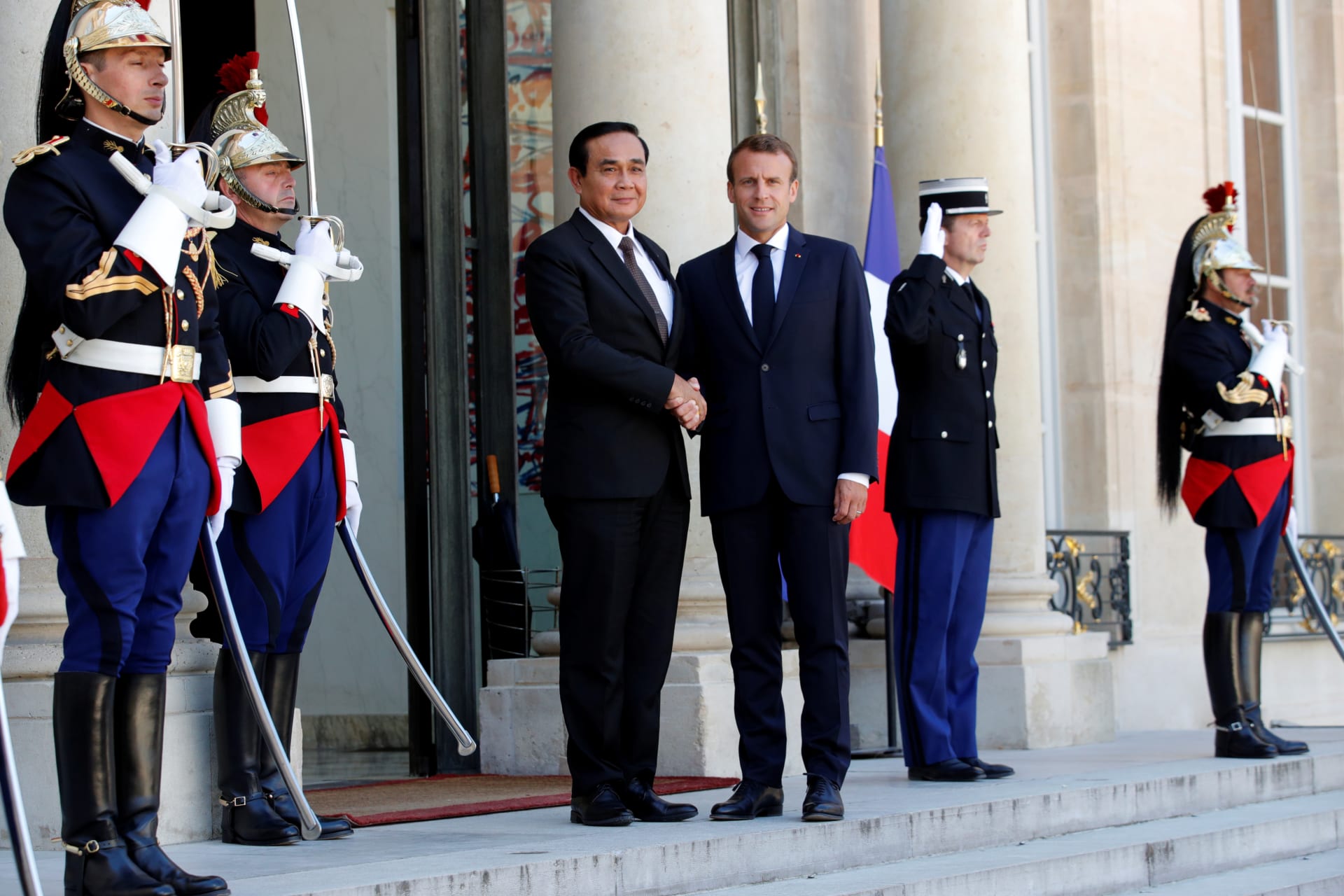 <p>French President Emmanuel Macron welcomes Thailand’s Prime Minister Prayuth Chan-ocha at the Elysee Palace in Paris, France, on June 25, 2018.</p>
