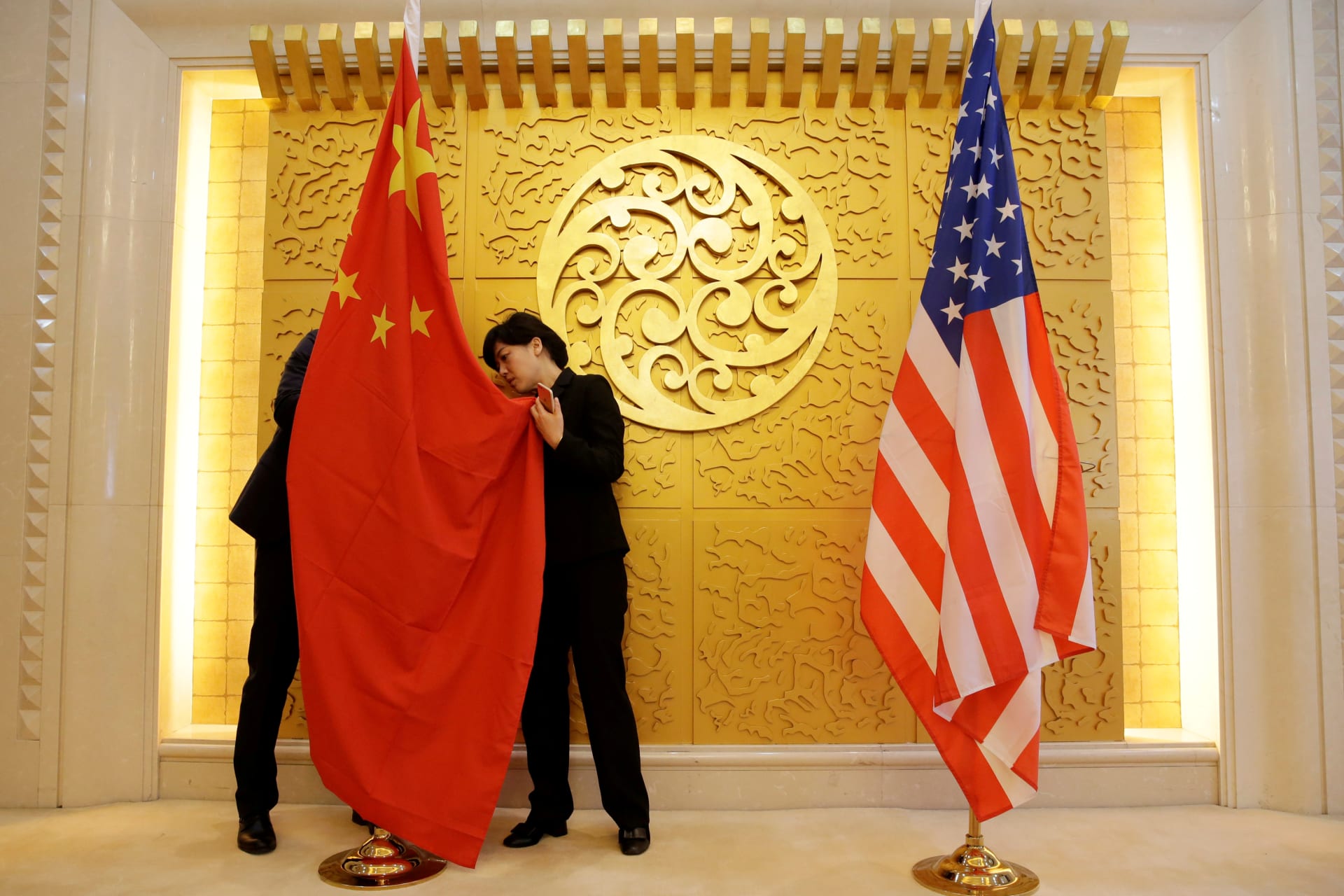 <p>Staff members set up Chinese and U.S. flags for a meeting between Chinese Transport Minister Li Xiaopeng and U.S. Secretary of Transportation Elaine Chao at the Ministry of Transport of China in Beijing, China April 27, 2018</p>
