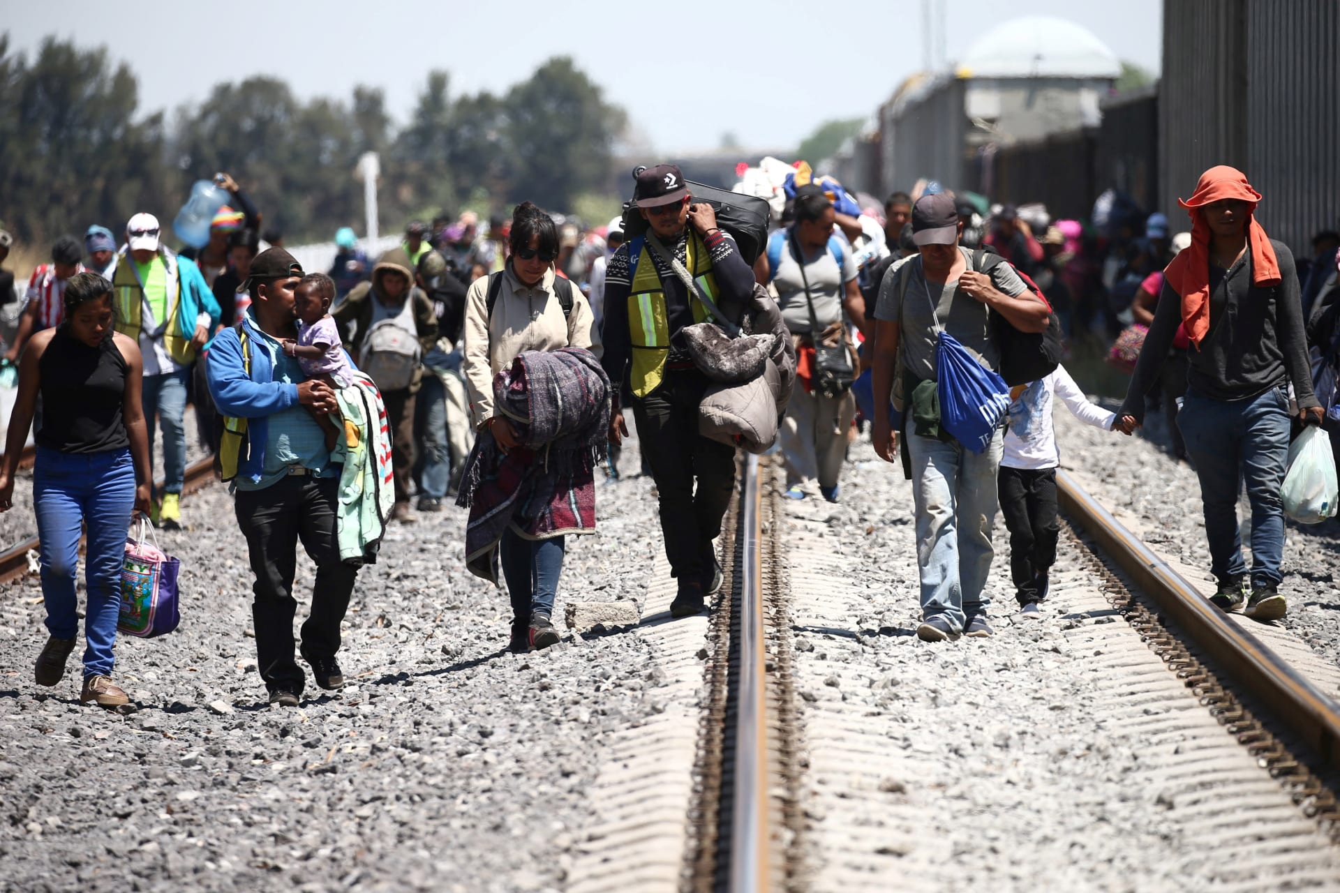 <p>Central American migrants disembark from a freight train as they walk on a railway track after stopping the train on a rail line, in Irapuato, Guanajuato state, Mexico April 15, 2018. </p>
