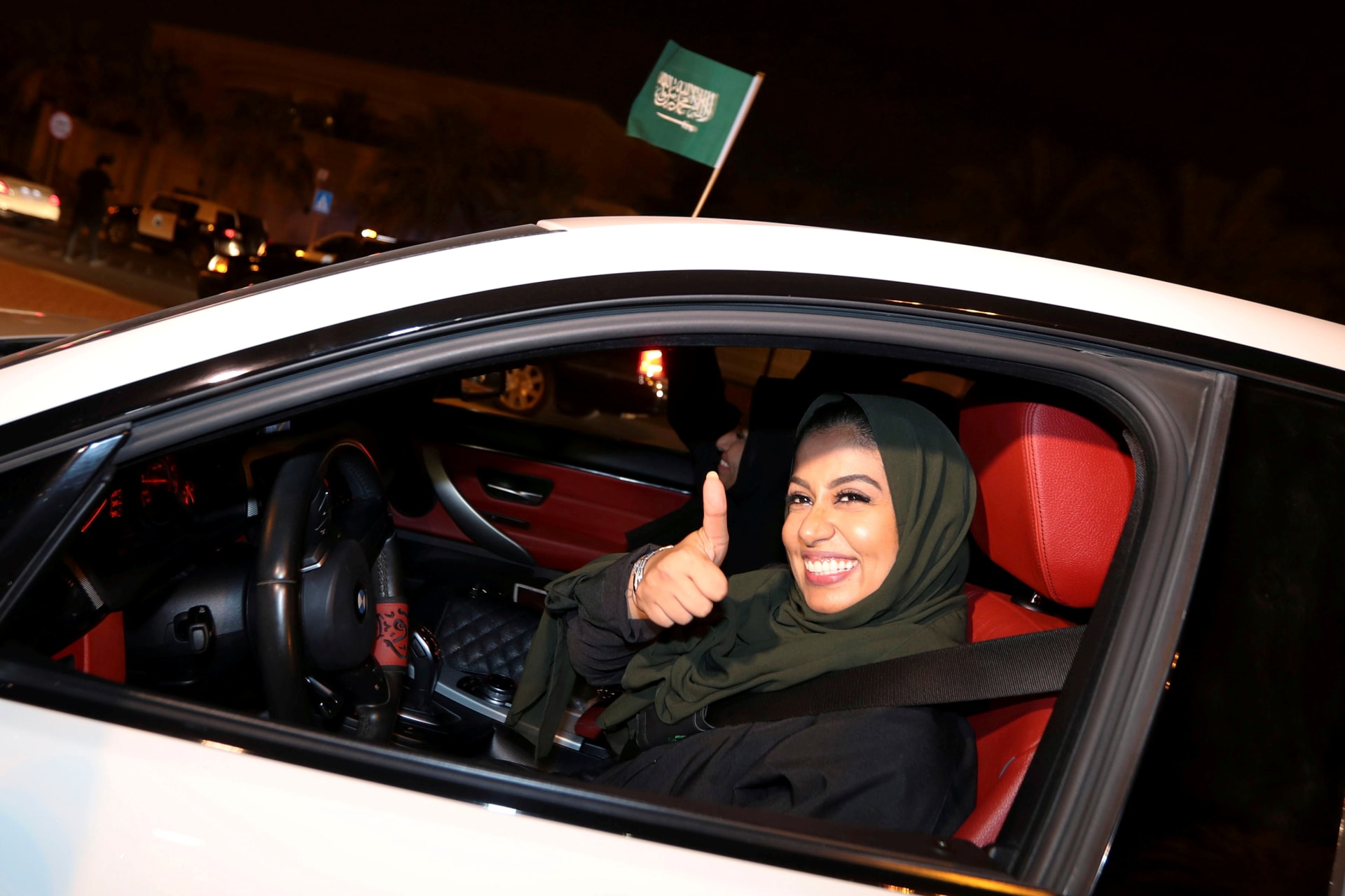 <p>A Saudi woman celebrates as she drives her car in her neighborhood, in Al Khobar, Saudi Arabia, June 24, 2018. </p>
