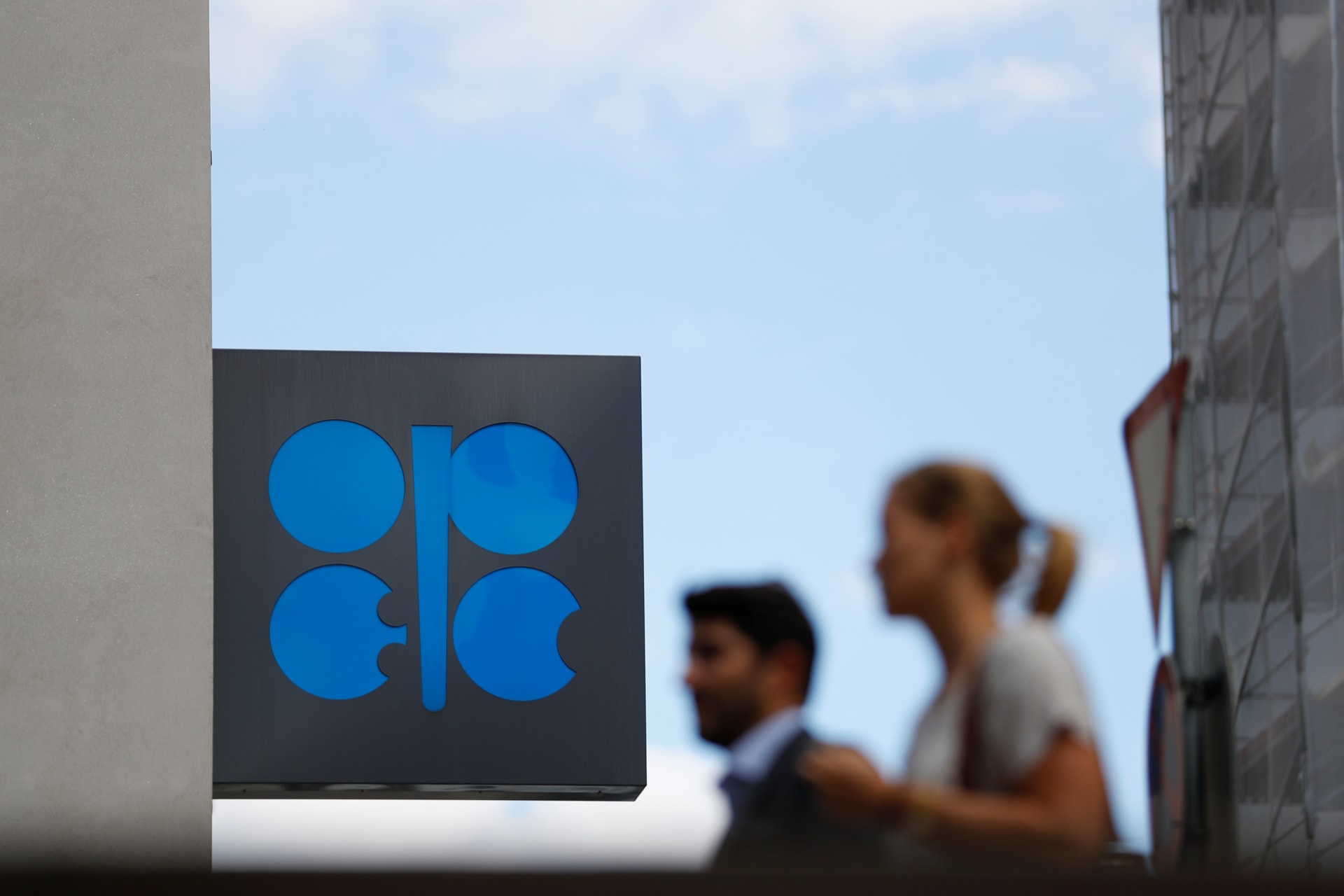 <p>Two persons pass the logo of the Organization of the Petroleoum Exporting Countries (OPEC) in front of OPEC’s headquarters in Vienna, Austria June 19, 2018. </p>
