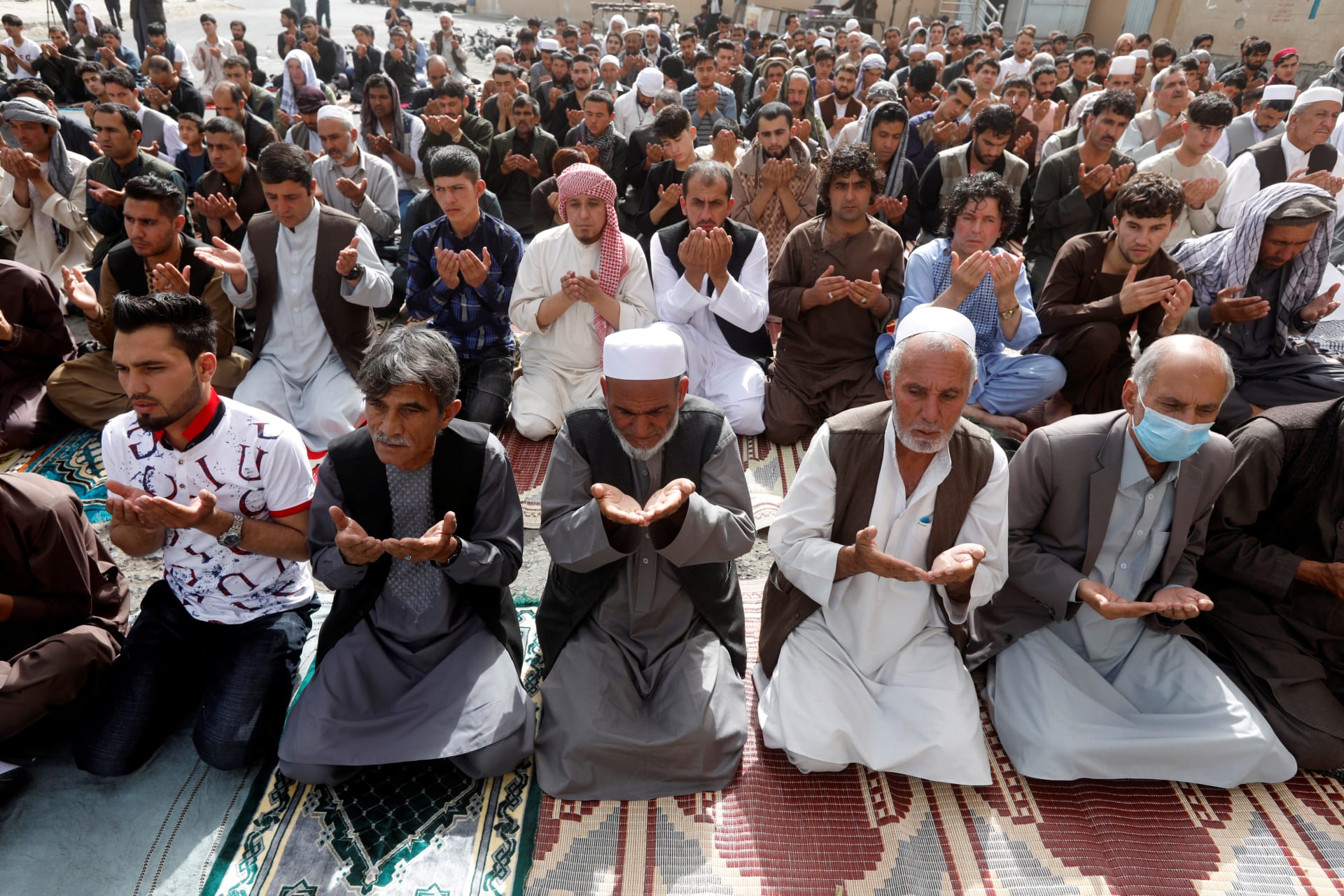 <p>People take part in morning prayers to celebrate the first day of the Muslim holiday of Eid al-Fitr, marking the end of the holy month of Ramadan, in Kabul, Afghanistan, on June 15, 2018.</p>

