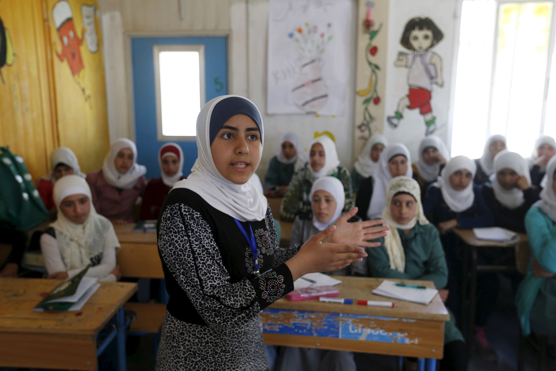 <p>Omayma al Hushan, 14, who launched an initiative against child marriage among Syrian refugees, speaks at a school in Al Zaatari refugee camp.</p>
