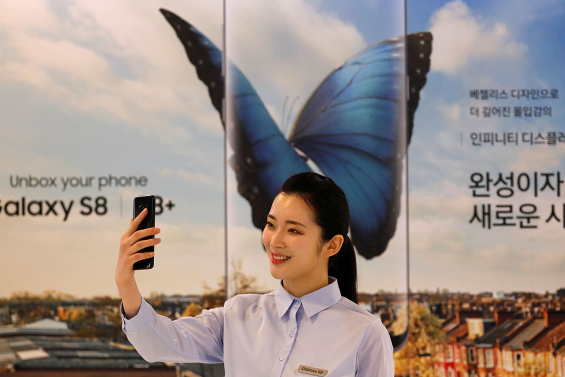 <p>A model poses with a Samsung smartphone. </p>
