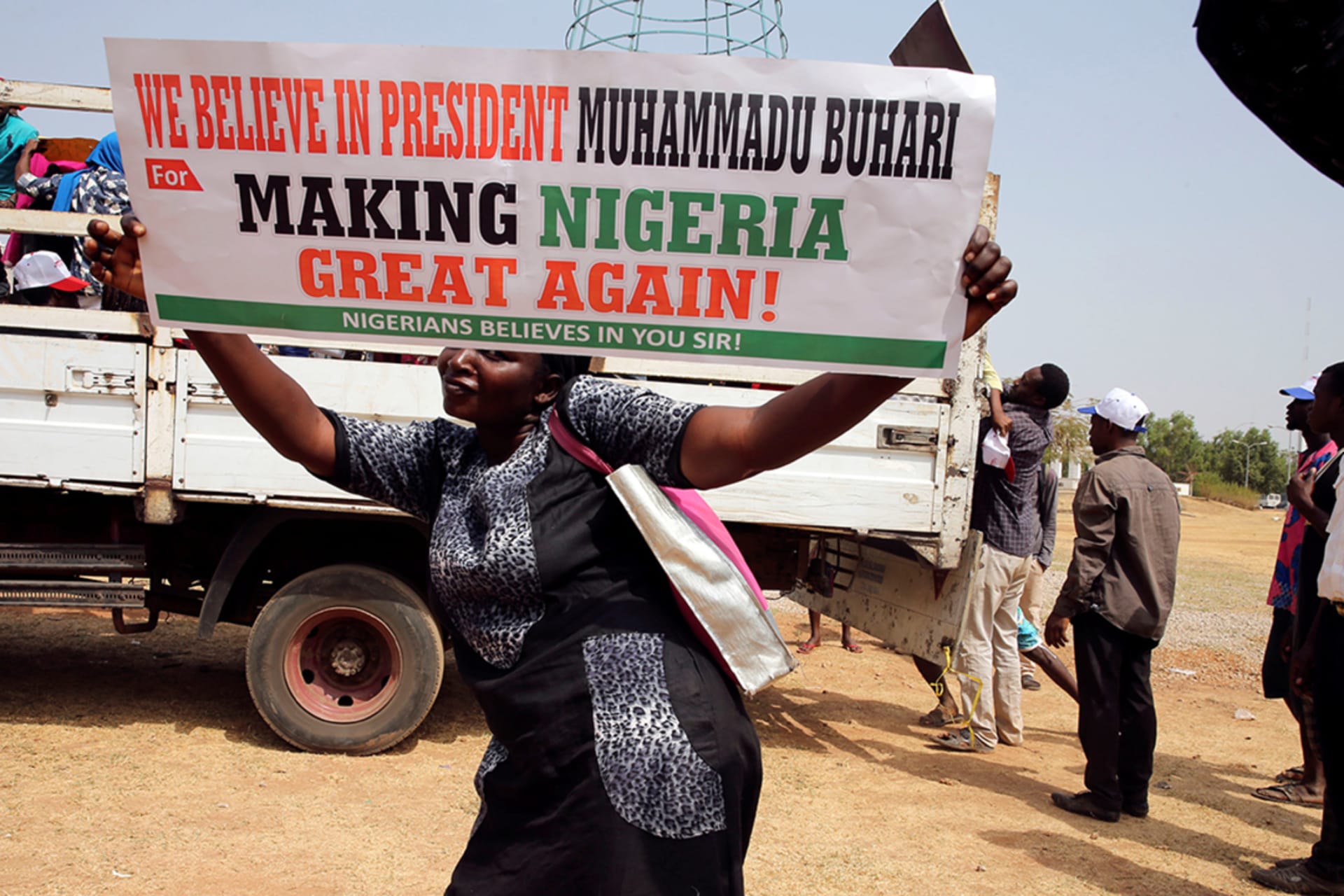 <p>A woman holds a placard during a rally in Abuja, Nigeria, to show support for President Muhammadu Buhari. </p>