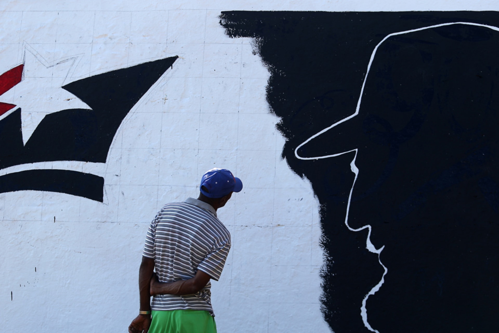 <p>A man looks at a mural representing Cuba’s late President Fidel Castro located along Cuba’s southern coast.</p>
