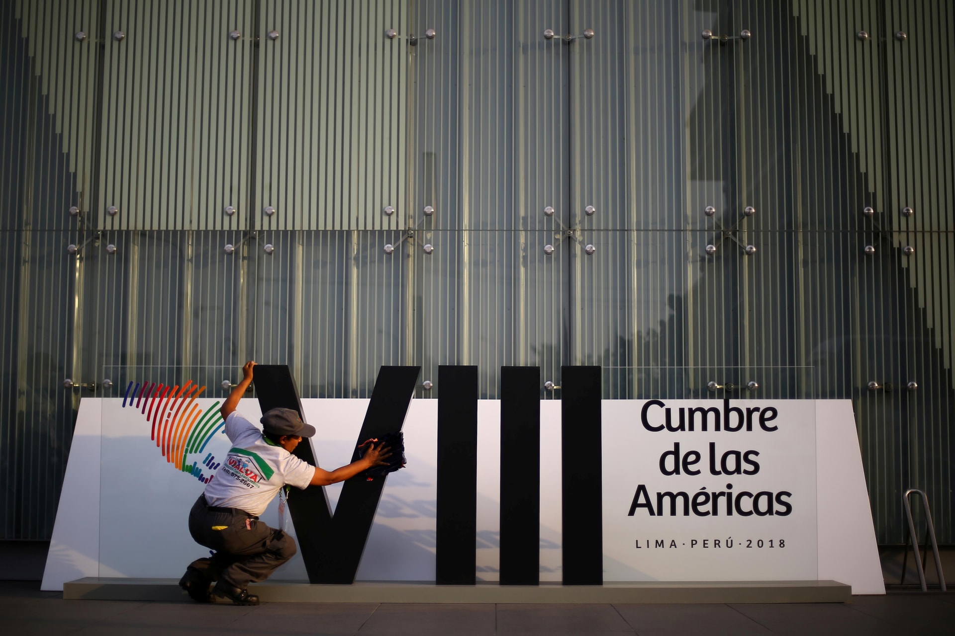 <p>A woman cleans a banner ahead of the eighth Summit of the Americas in Lima, Peru April 10, 2018. </p>
