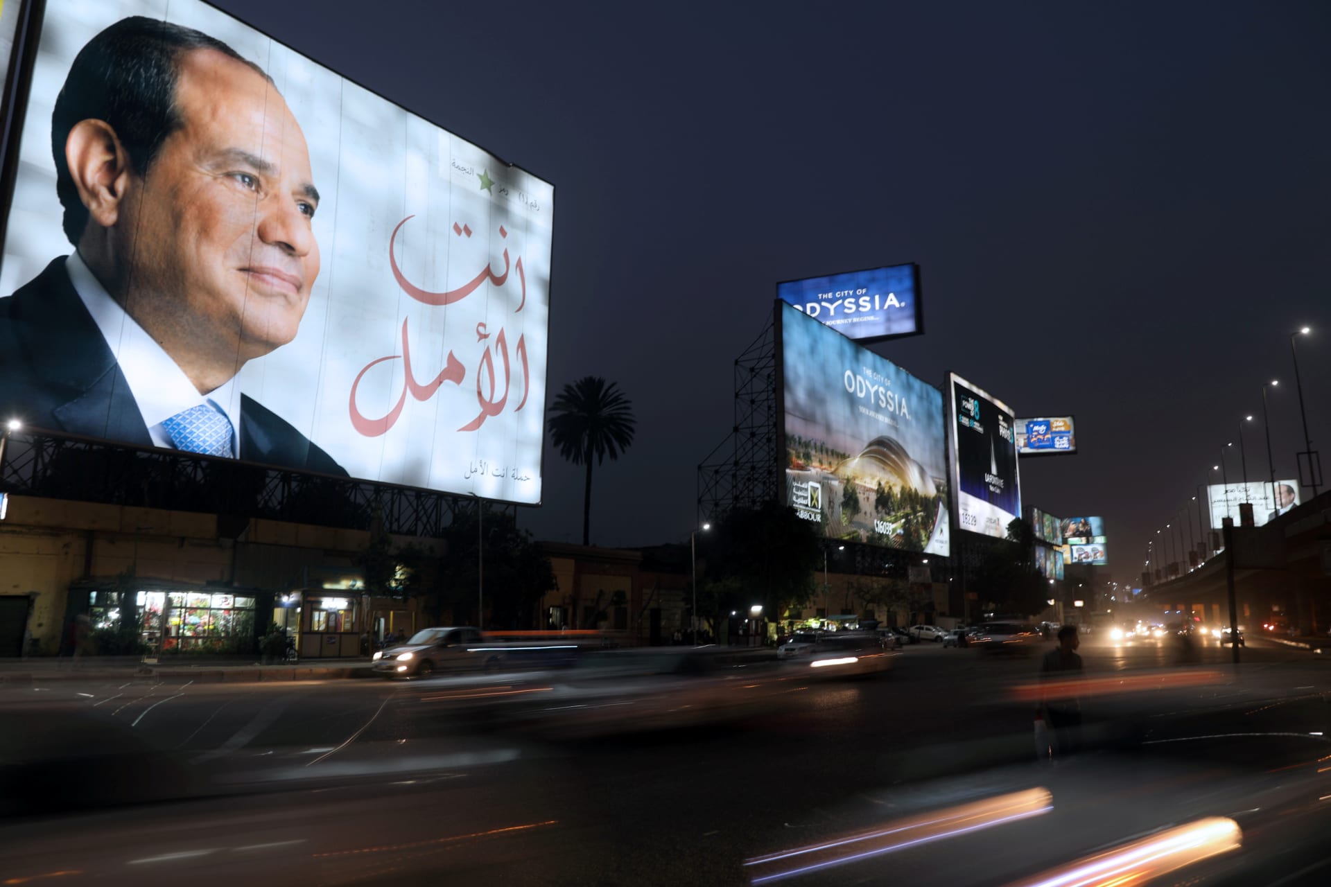 <p>People walk in front of banners with Egypt’s President Abdel Fattah al-Sisi during preparations for the presidential election in Cairo </p>