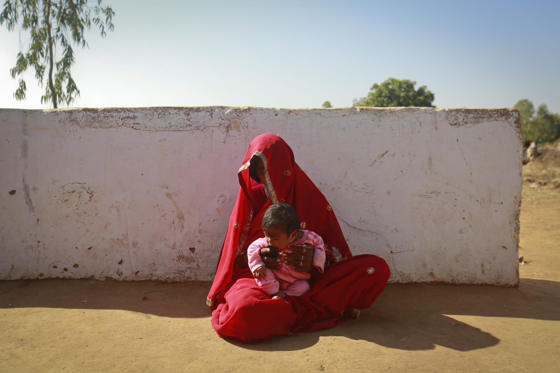 <p>Krishna, 14, sits with her four-month-old baby Alok outside her house in a village near Baran, located in the northwestern state of Rajasthan, January 21, 2013. Krishna was married to her husband Gopal when she was 11 and he was 13. </p>
