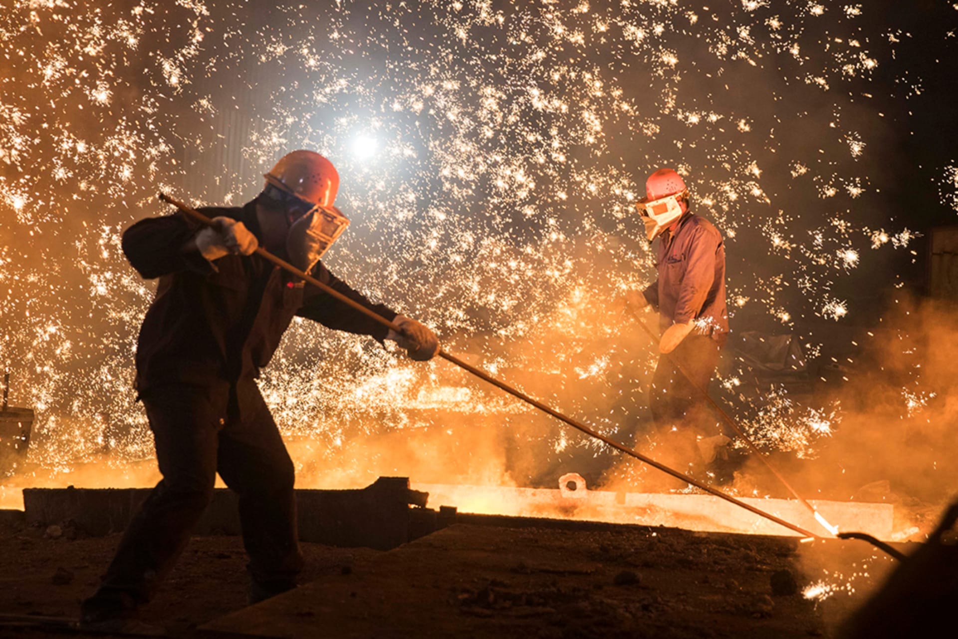 <p>Workers at a steel plant in Shandong province, China, in July 2017.</p>
