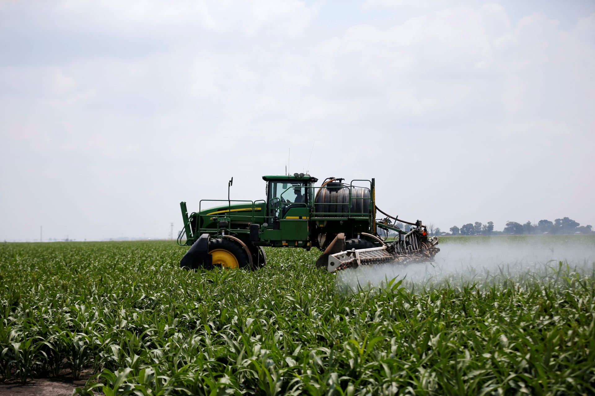 <p>A worker uses a tractor to spray a field of crops during crop-eating armyworm invasion at a farm in Settlers, South Africa, February 8, 2017. Central to land reform is its effect on food security, which Ramaphosa has promised to maintain.</p>
