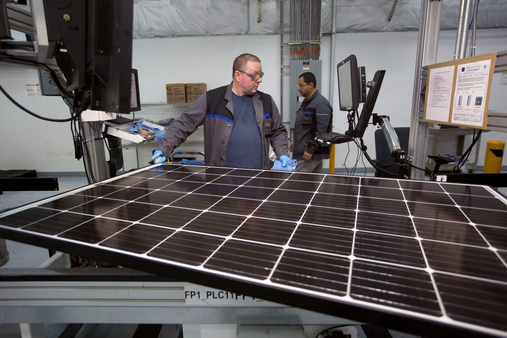 <p>A worker checks a solar panel at a factory in Hillsboro, Oregon.</p>
